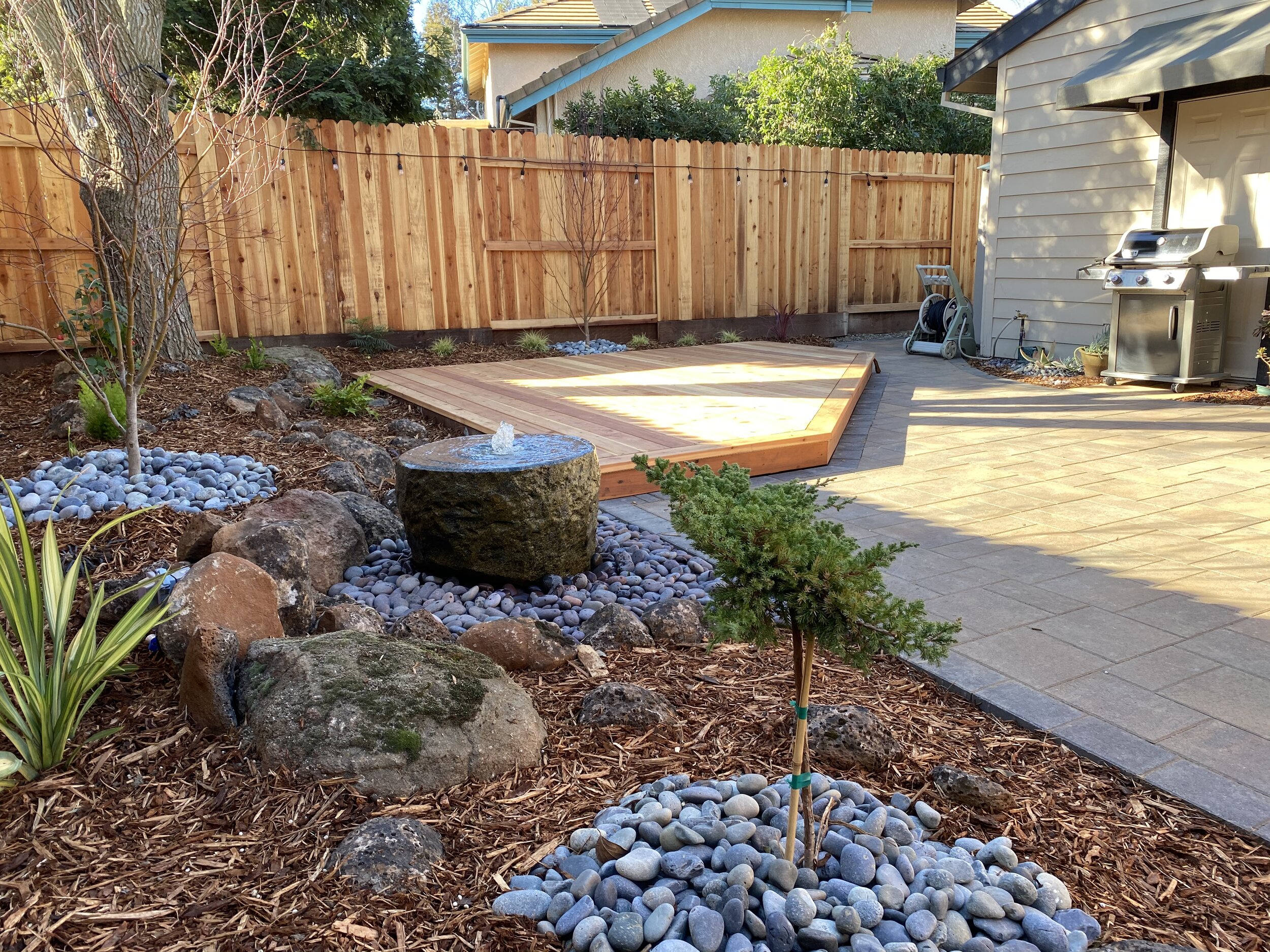  New fountain, redwood deck, paver patio, plantings, irrigation and mulch. 