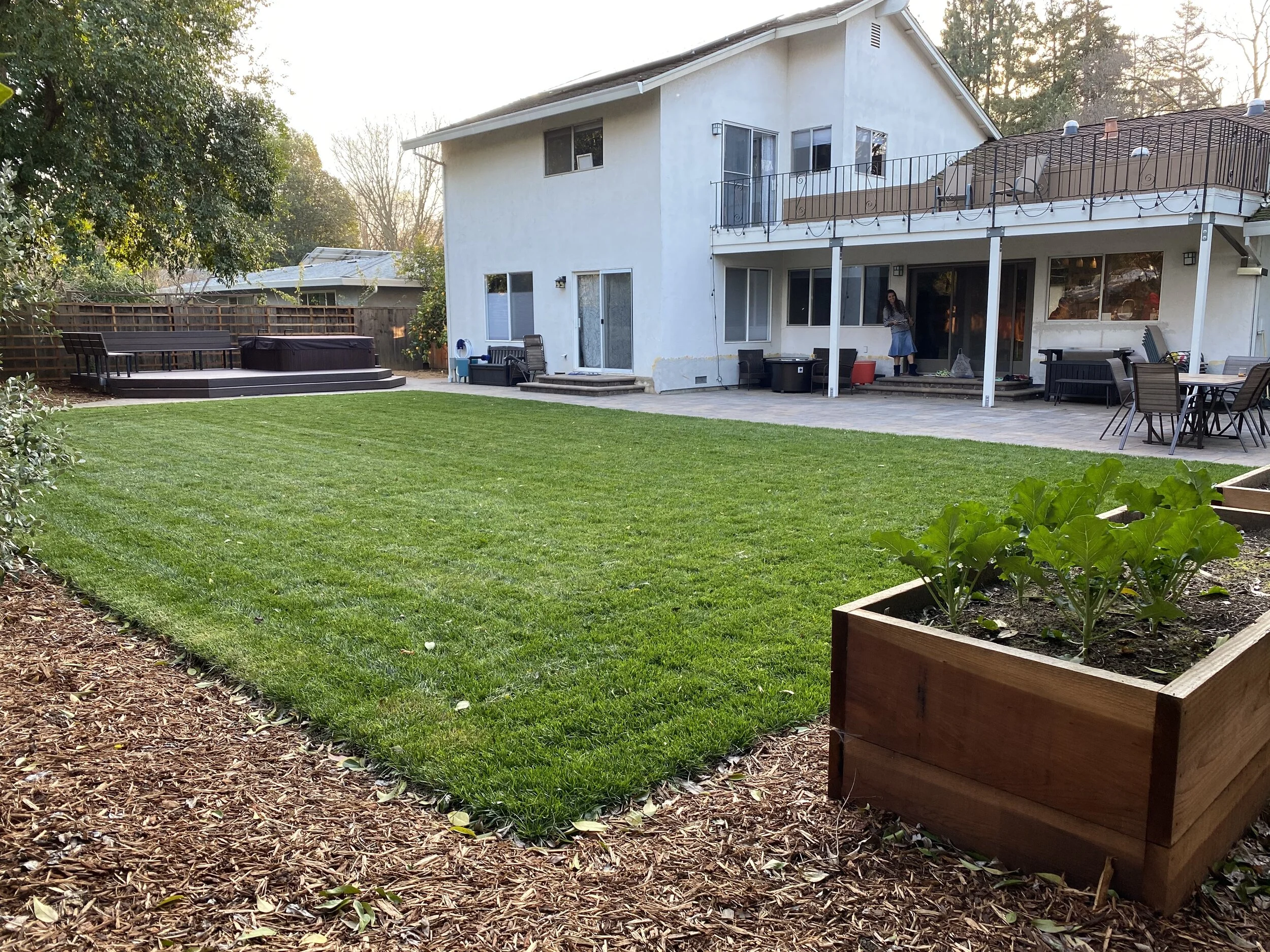  New paver patio, deck, hot tub, lawn and veggie planters make for an open and usable space. 