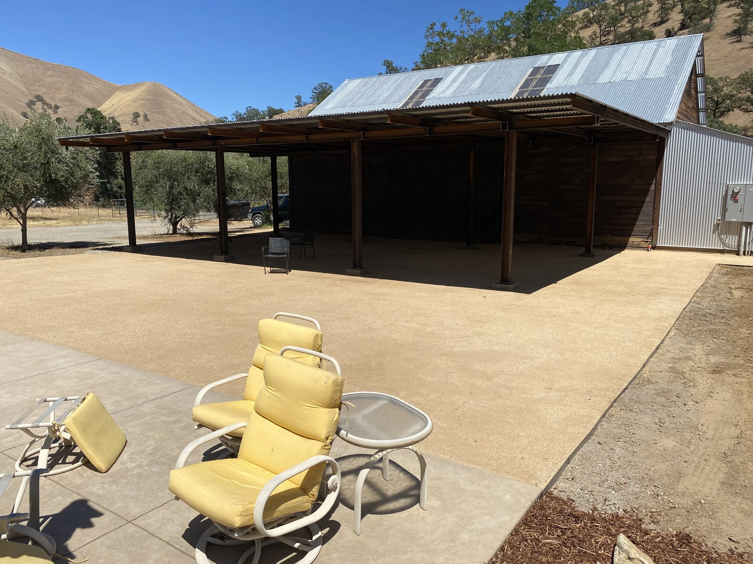  This decomposed granite patio creates a usable patio space between the party barn and pool. 