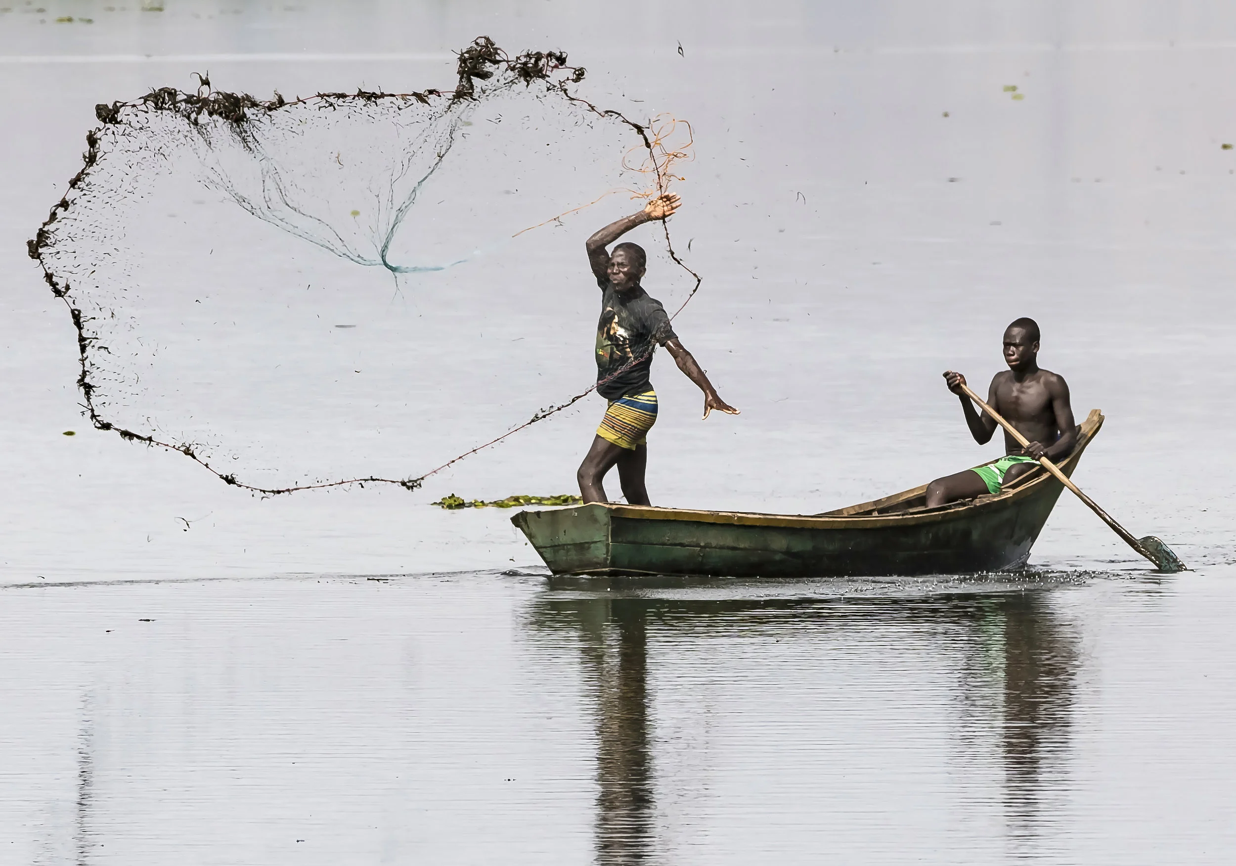 Fishermen casting Net, Lake Albert, Uganda