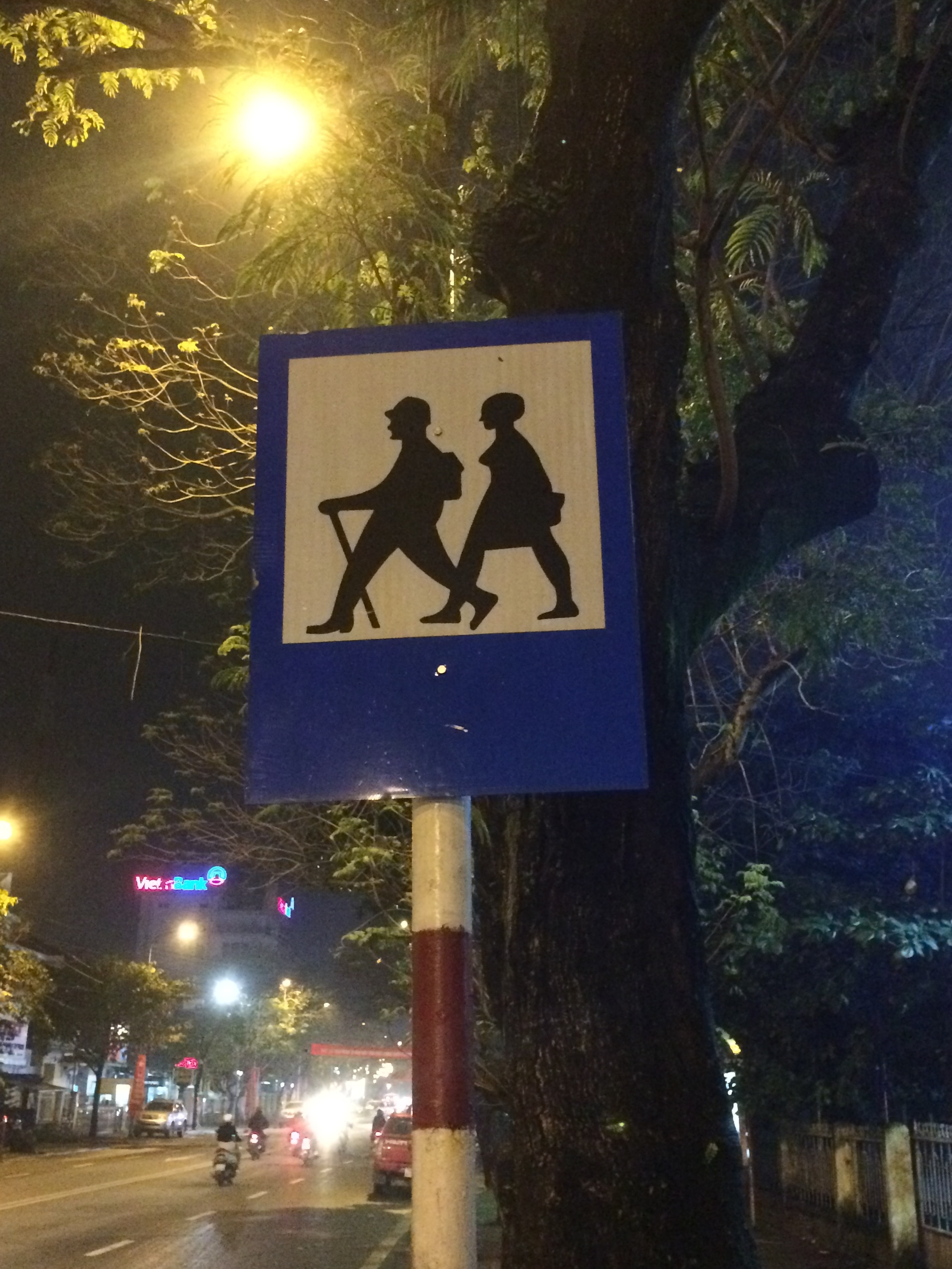 A crossing sign in Hue, Vietnam - are we supposed to identify with the silhouettes of these people? Hmmmmm. If you are not riding a motor scooter, I guess they assume you are a hitch hiker. Hue, Vietnam.