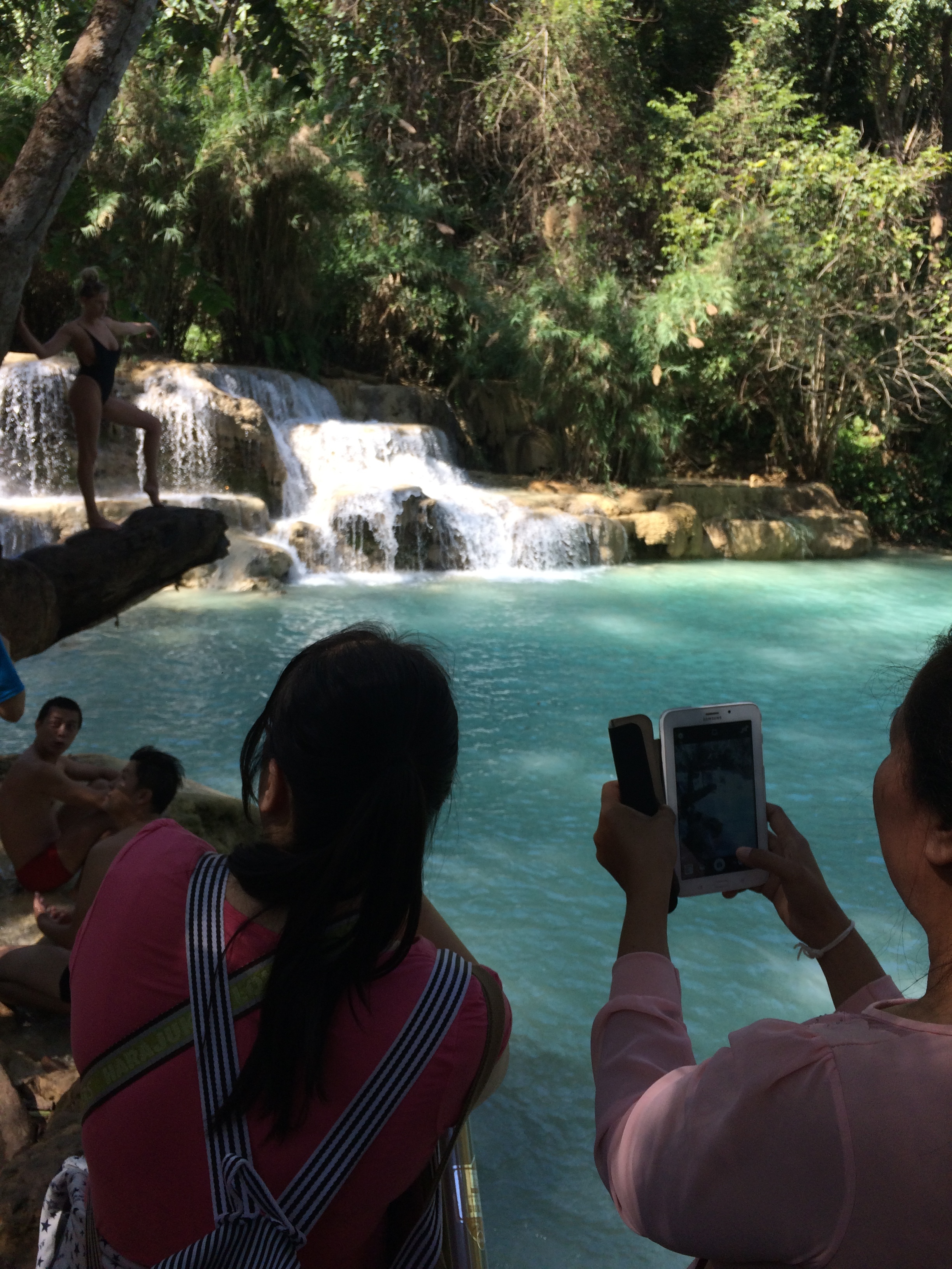 These Chinese tourists came to take pictures of american girls modeling, and there happens to be a waterfall in the background too. Kuang Si Waterfall, Loas.