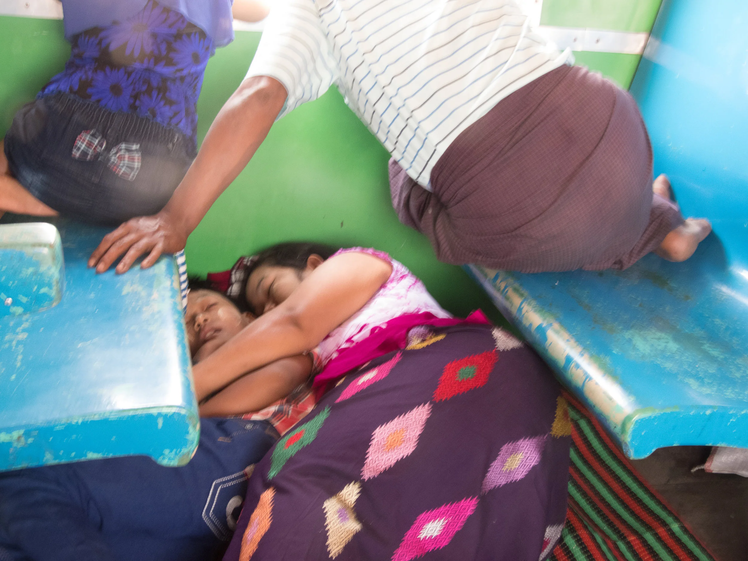 Family and friends are affectionate towards each other in Myanmar. Here, the mother and son sleep below the seats.