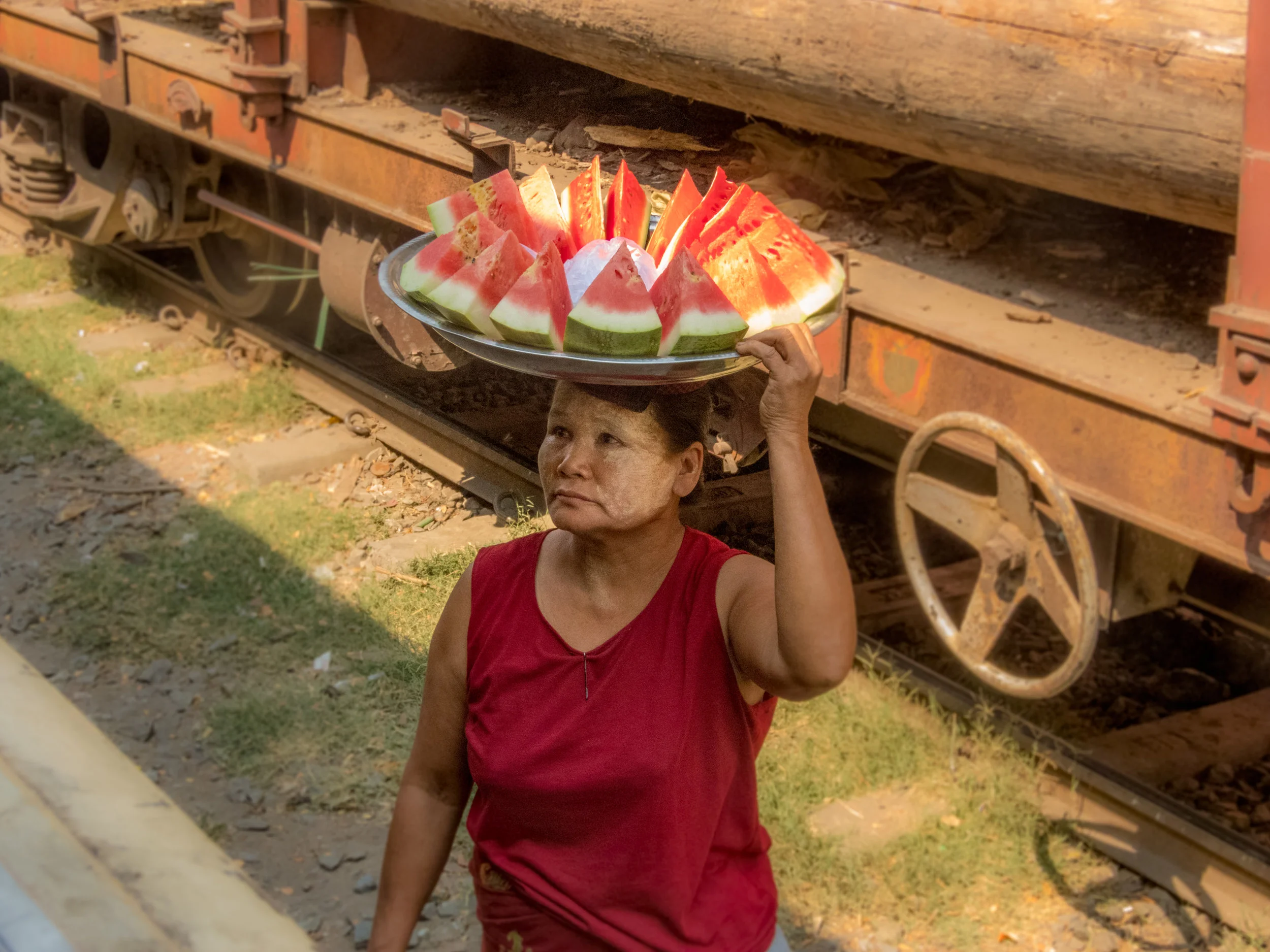 People walk up to the windows to sell food.