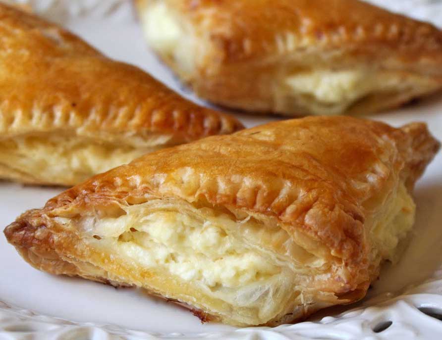 Tiropites Greek layered pastry food in the burek family, made with layers of buttered phyllo and filled with a cheese-egg mixture