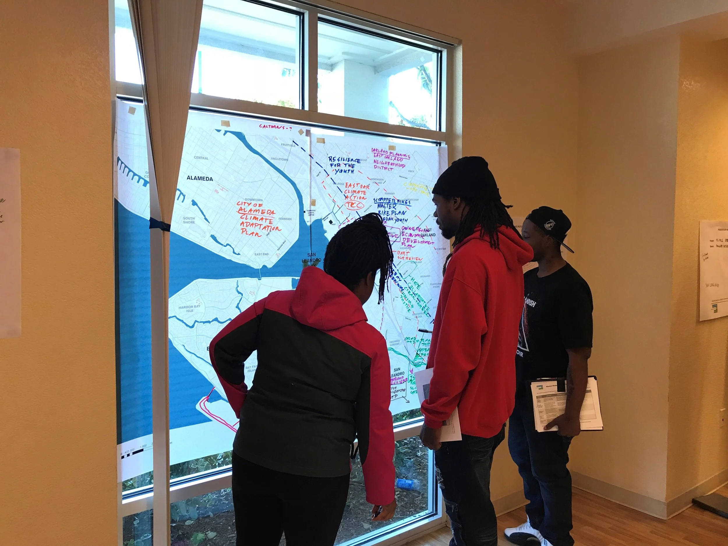 Pens in hand, representatives from the East Oakland Collective and Scraper Bike Team sketch their priorities for a resilient San Leandro Bay