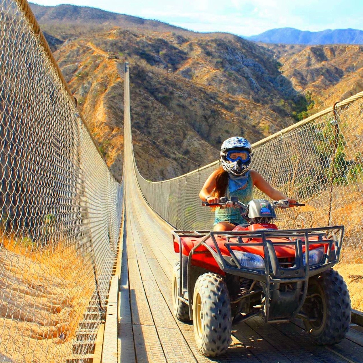 Jessica, ATV riding in Cabo along the longest suspension bridge.