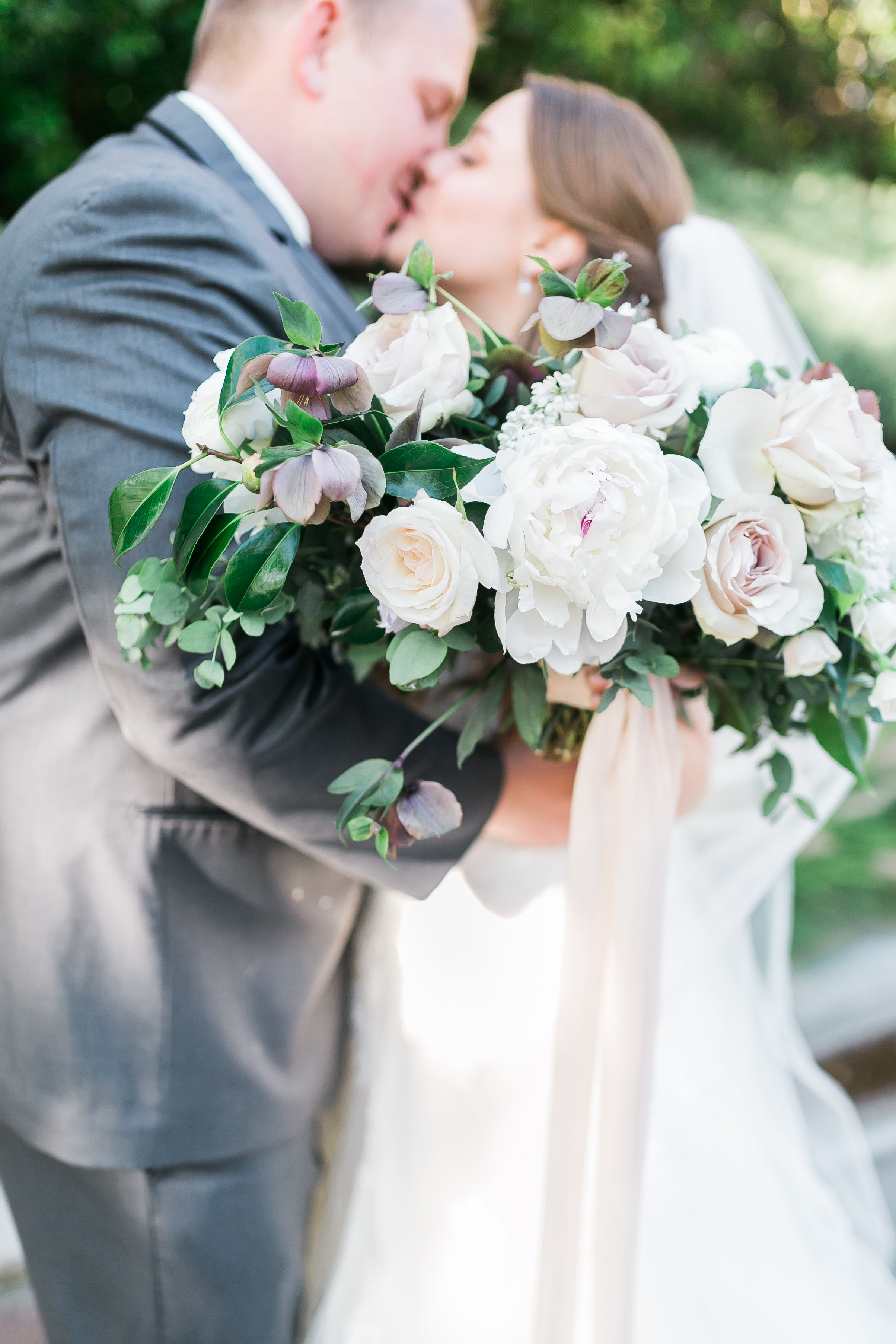 Bridal bouquet of hellebore, peonies, ranunculus and other spring florals. 