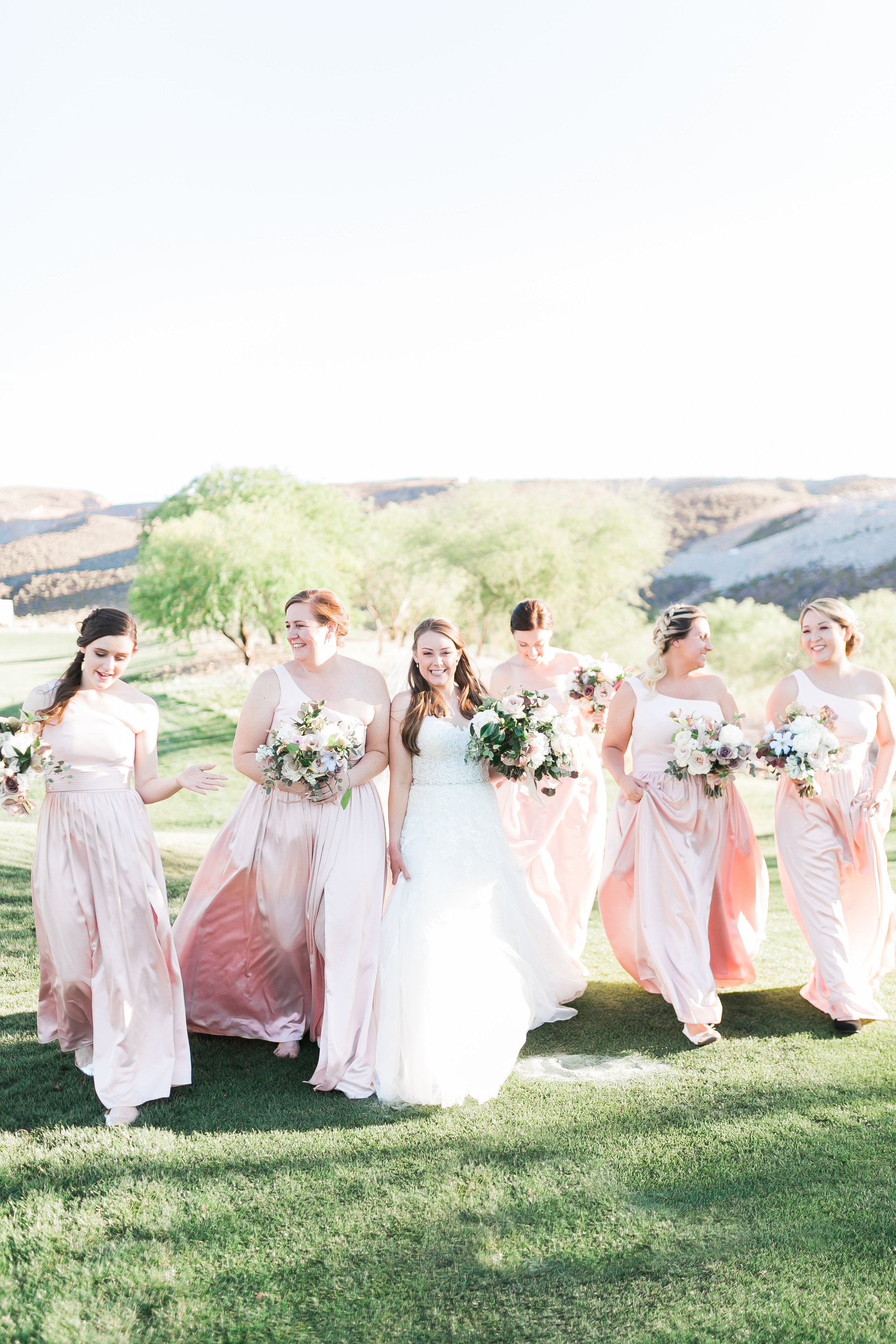 Bridal squad with bridesmaids in blush dresses. 