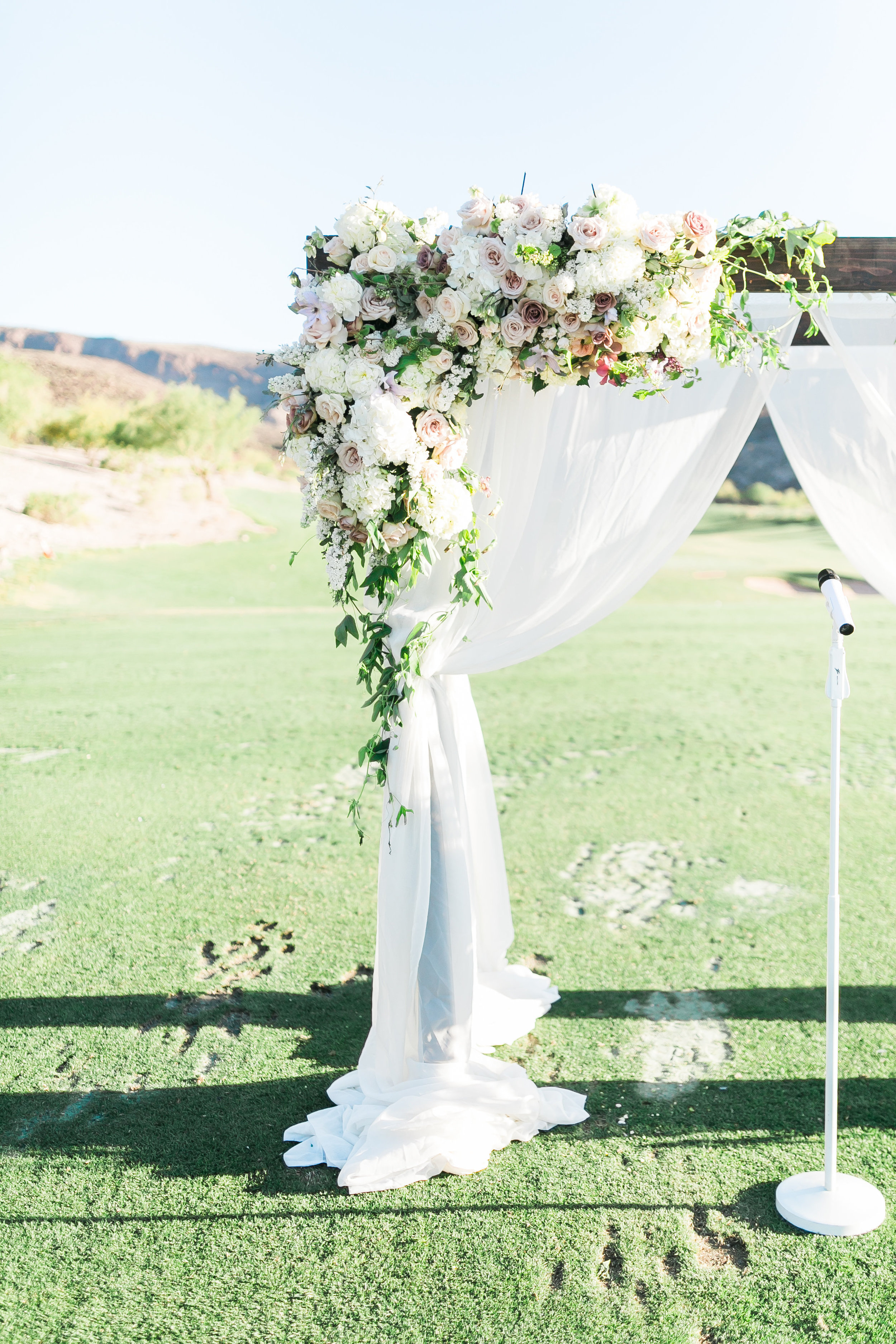 Asymmetrical florals on wedding arbor. Colorado wedding floral designer, Layers of Lovely 