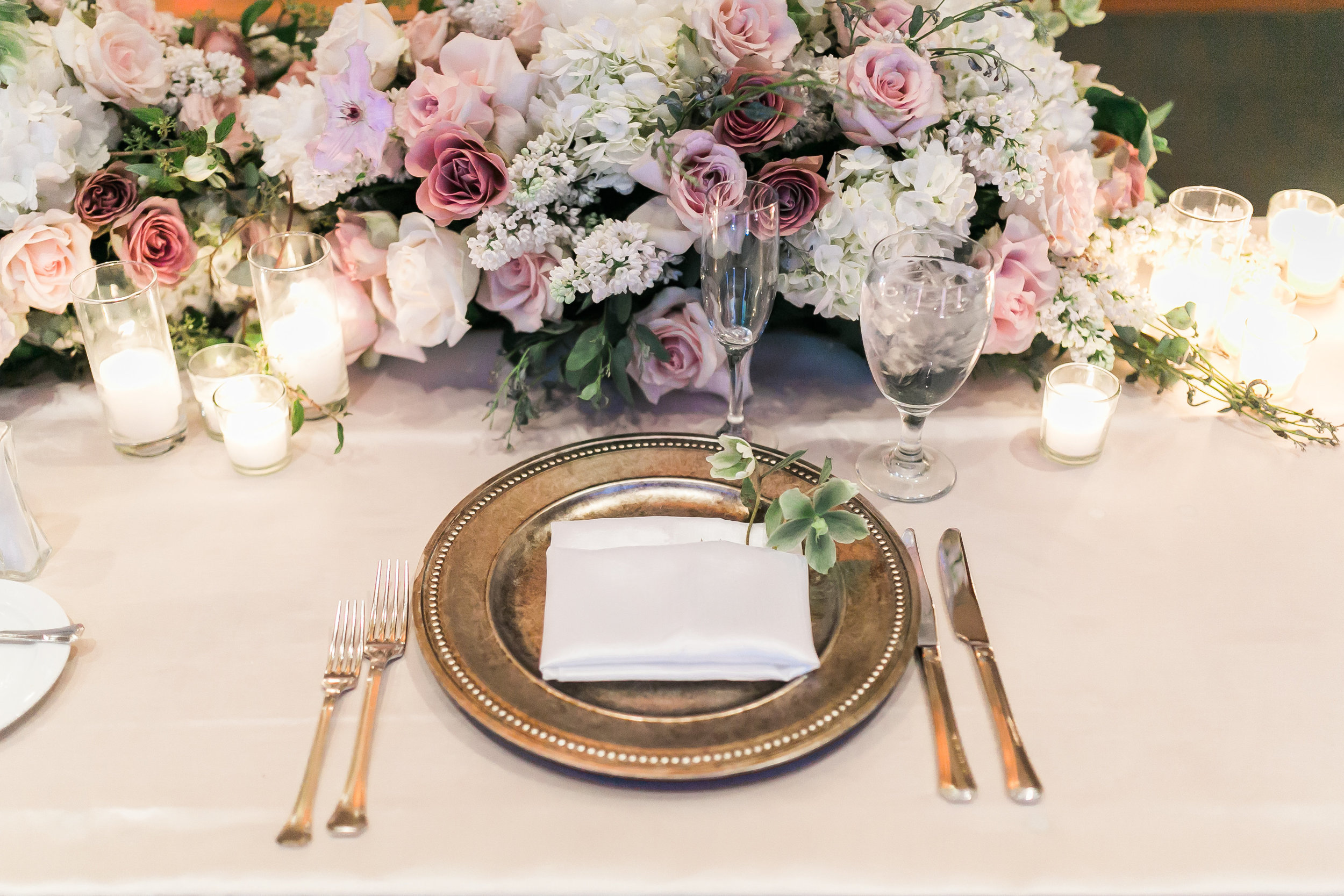 Long, low floral arrangement for the sweetheart table. 