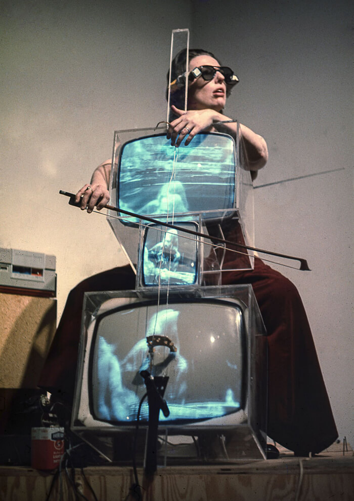 Charlotte Moorman performing on Nam June Paik's TV Cello wearing TV Glasses, Bonino Gallery, New York City, 1971 Photo: Takahiko Iimura. © Takahiko Iimura