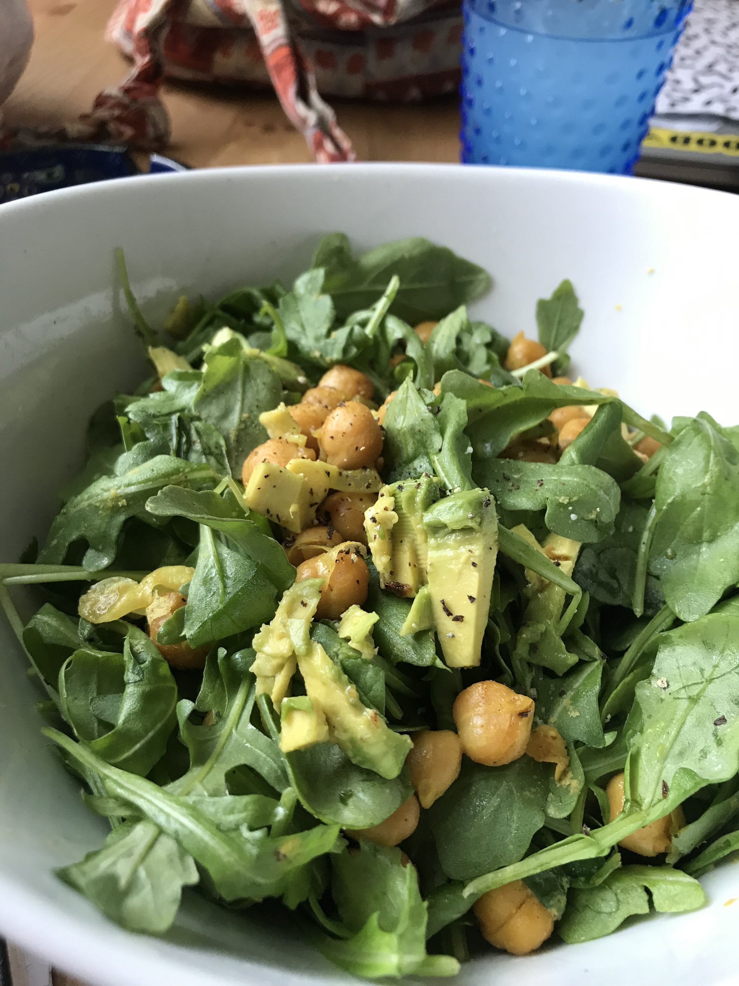 Arugula salad with curry chickpeas and avocado.