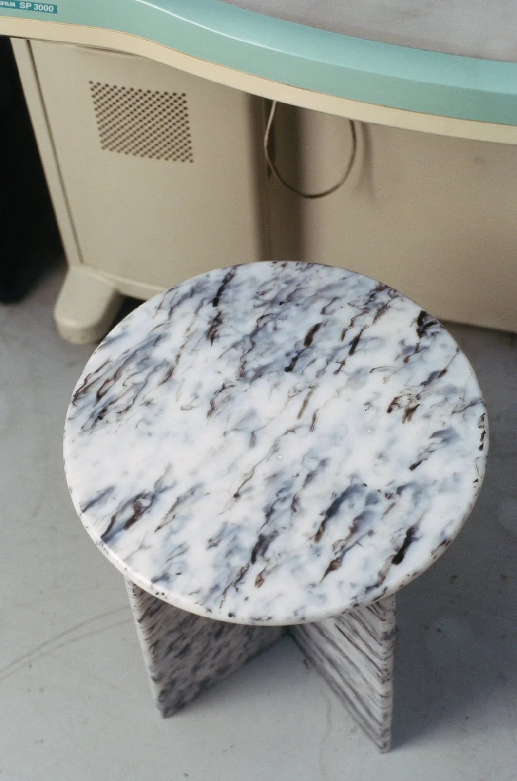 Top view of the No.1875 recycled film side table showing its unique marbled surface
