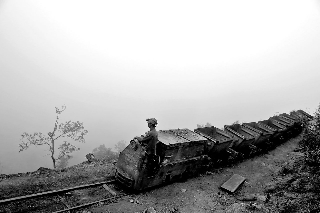An Iranian coal miner moves wagons to be loaded with coal at a mine near the city of Zirab 132 miles northeast of the capital Tehran on a mountain in Mazandaran province, Iran on May 8, 2014. (Photo: Ebrahim Noroozi/AP)