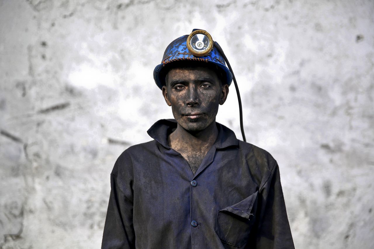 An Iranian coal miner with his face smeared black from coal poses for a photograph at a mine near the city of Zirab 132 miles northeast of the capital Tehran, on a mountain in Mazandaran province, Iran on May 7, 2014. (Photo: Ebrahim Noroozi/AP)