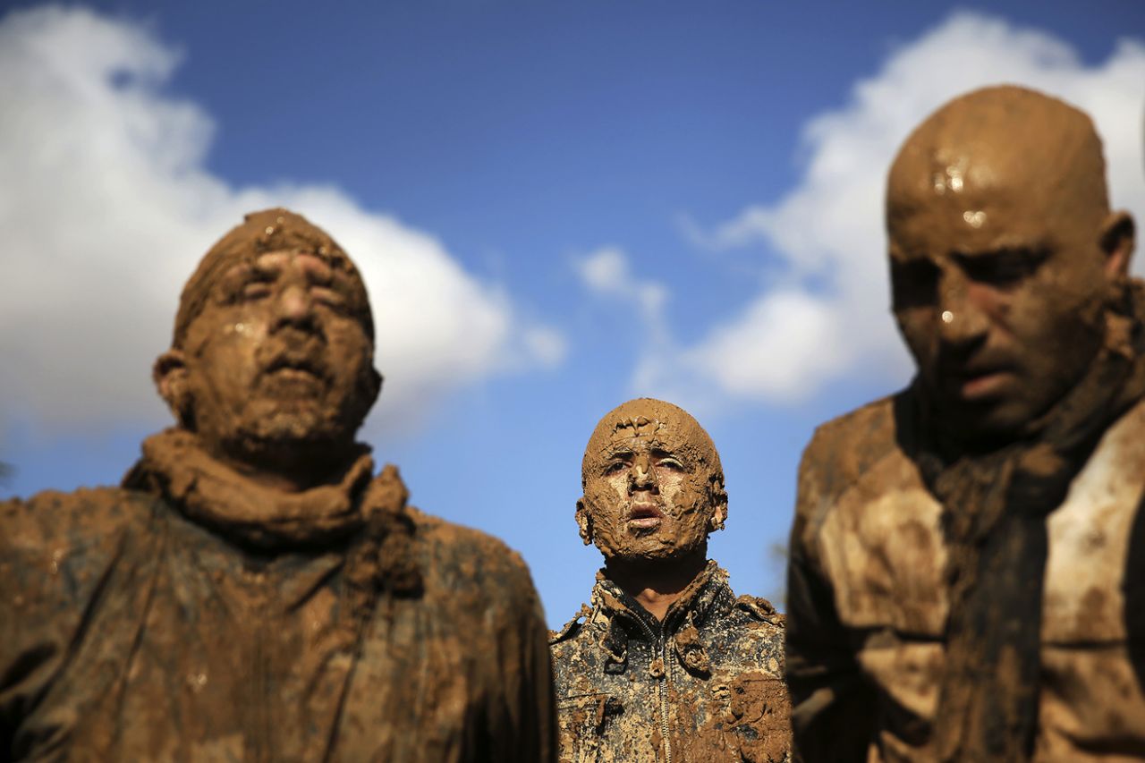 Iranian Shiites cover themselves with mud during Ashoura, marking the death anniversary of Imam Hussein, the grandson of Islam’s Prophet Muhammad, at the city of Bijar, west of the capital Tehran, Iran, Nov. 14, 2013. (Photo: Ebrahim Noroozi/AP)