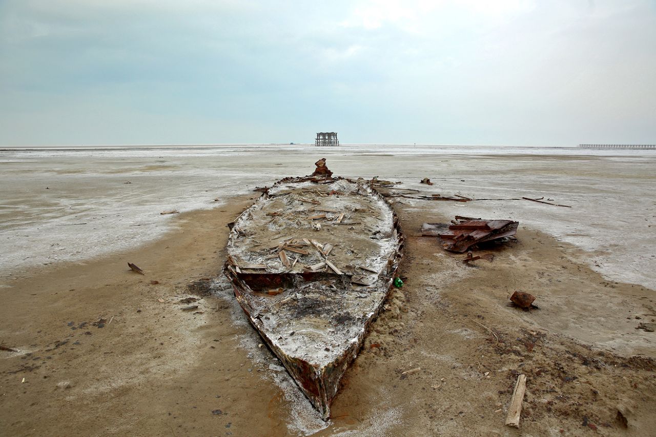 The wreckage of a boat is stuck in the solidified salts and sands at Lake Oroumieh, northwestern Iran, Feb. 16, 2014. (Photo: Ebrahim Noroozi/AP)