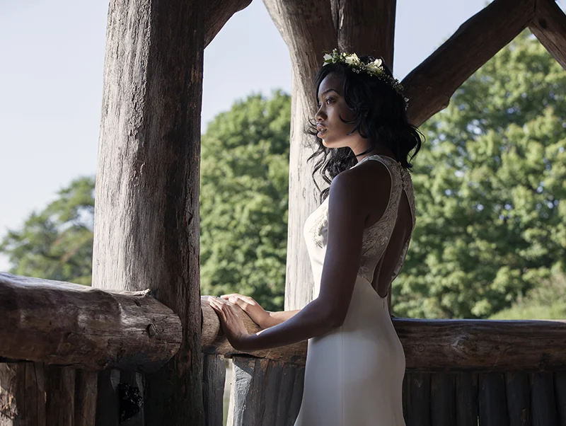 The keyhole back on the Lola dress in silk organza, embroidered with seed beads, faux pearls, tiny crystals, and leaf pailletes to create a floral vine running up the back.