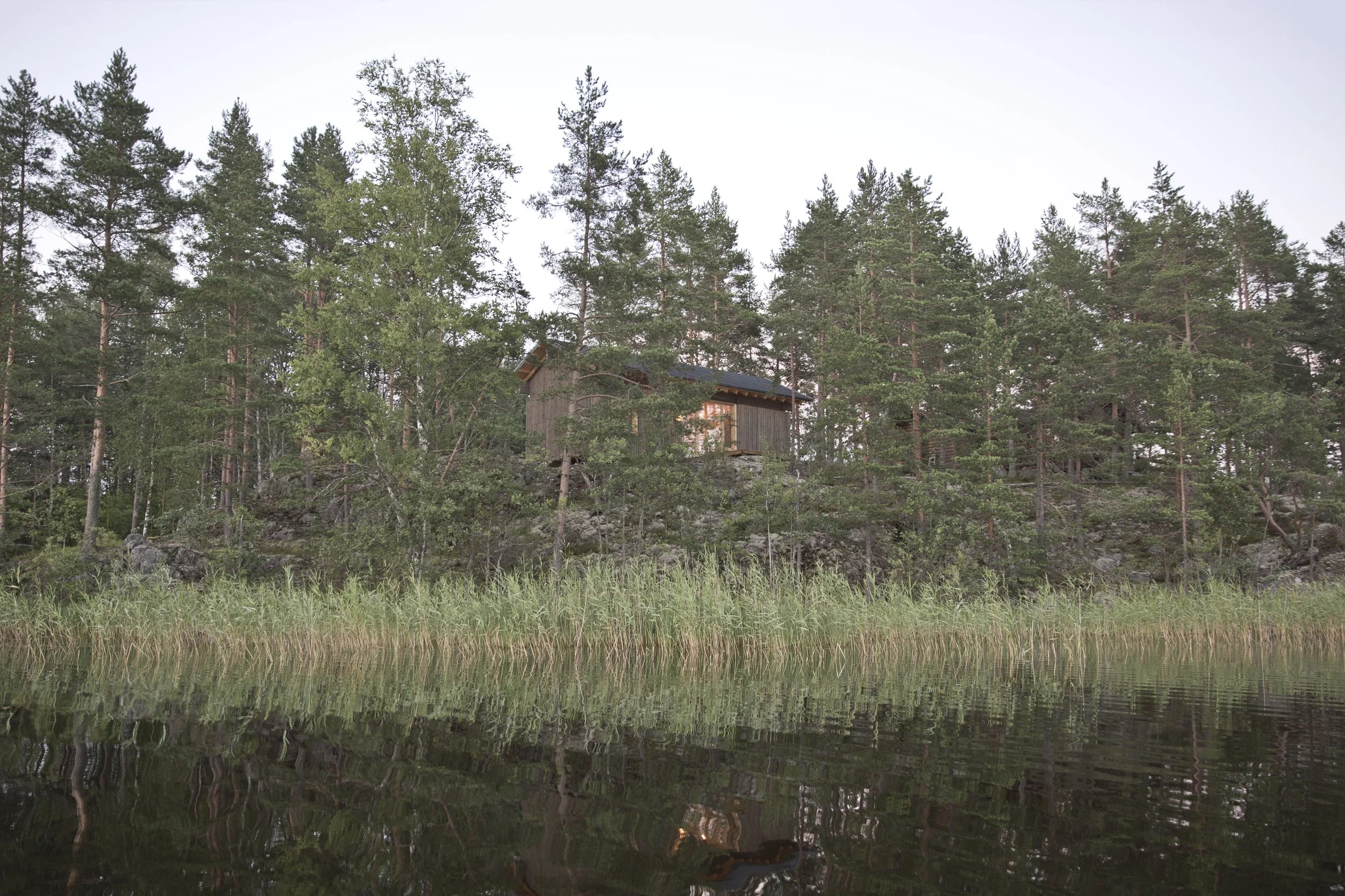 waterfront cabin, weathered exterior, indoor outdoor living, Scandinavian architecture, Nordic design