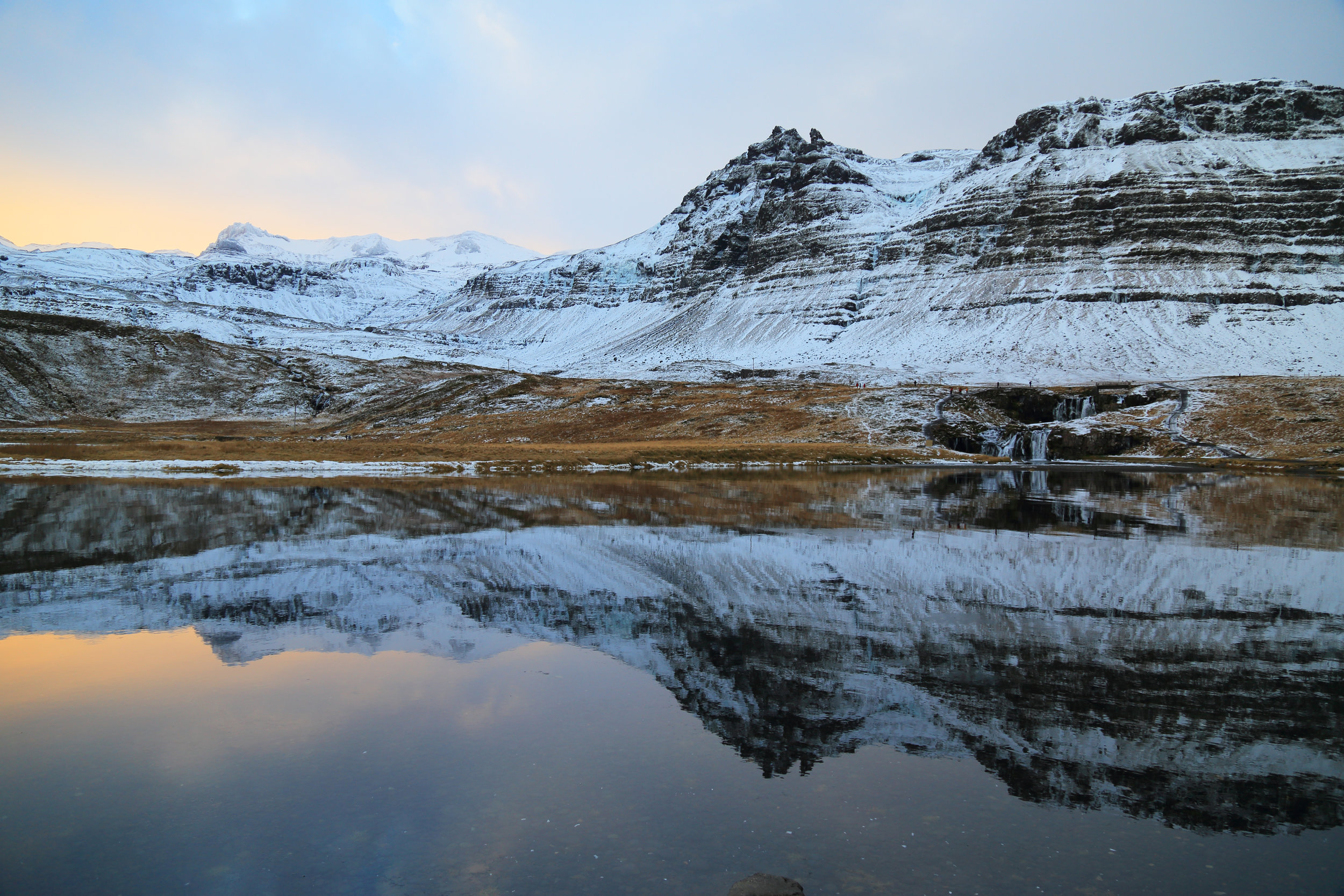 Kirkjufellsfoss and its reflection at sunrise