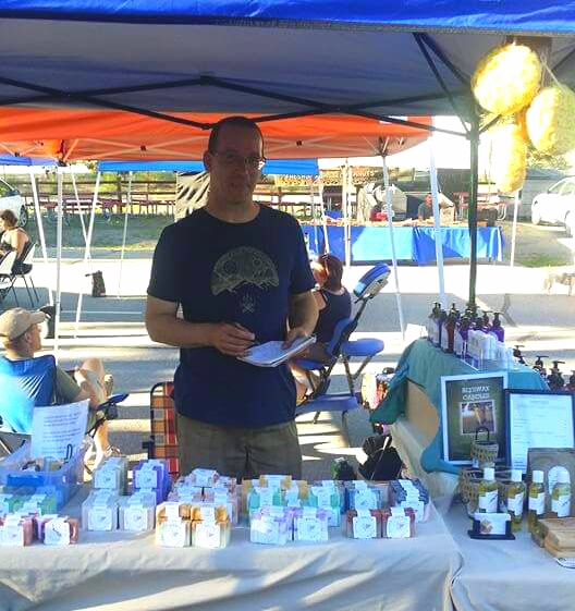 Whole Life Soaps' Owner, Bill McConnell selling soaps and lotions at a local farmer's market. Photo Credit: Laurie McConnell