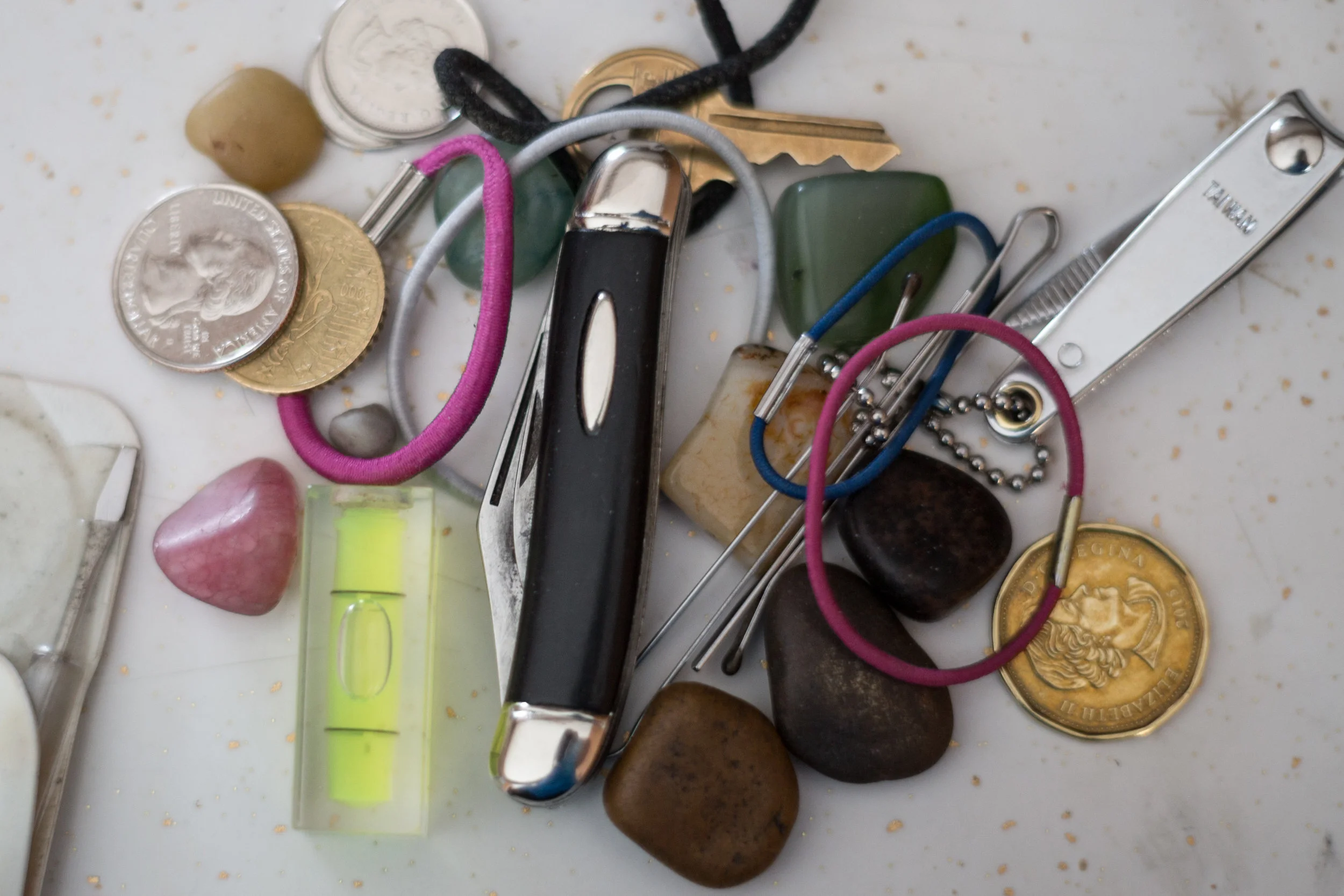  My dad's pocket contents. When I was younger, I had long hair as did my sisters. We were constantly losing our hair ties and my dad had them on hand for us. We used to give him little rocks which he still has.&nbsp; 