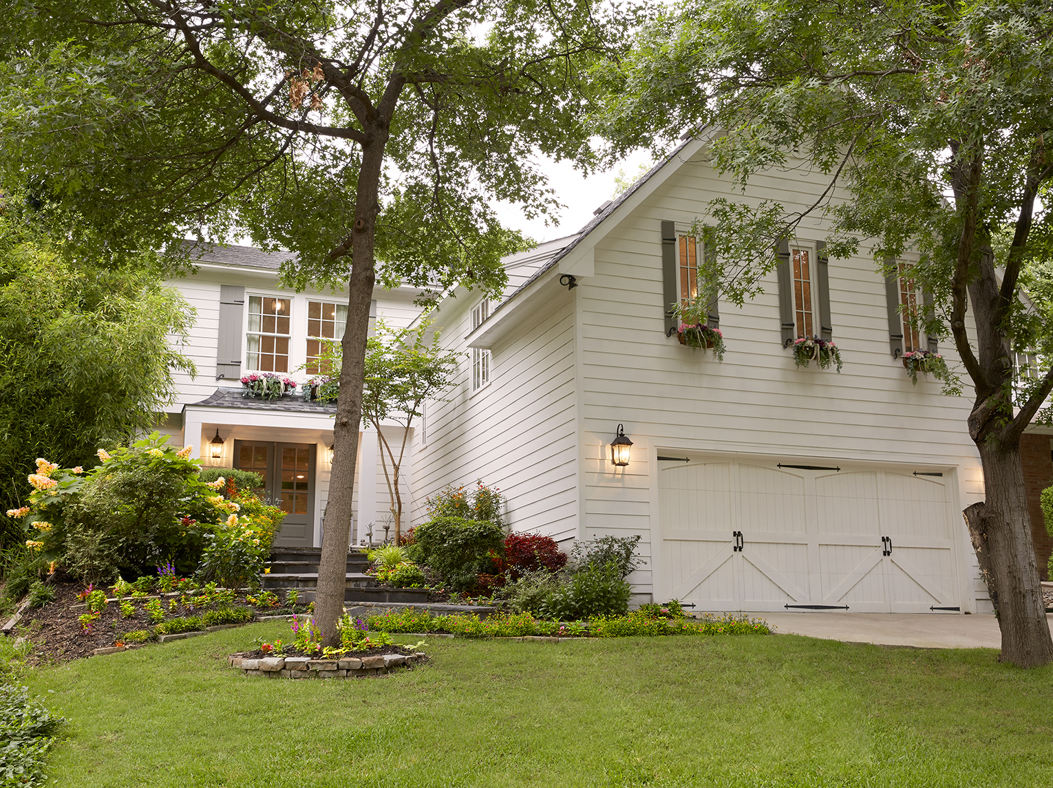 The farmhouse feel of the home’s exterior influenced Emily's decor choices for the interior. When her family purchased the home, she painted the front doors and added an overhang, shutters, flowerboxes and new landscaping.