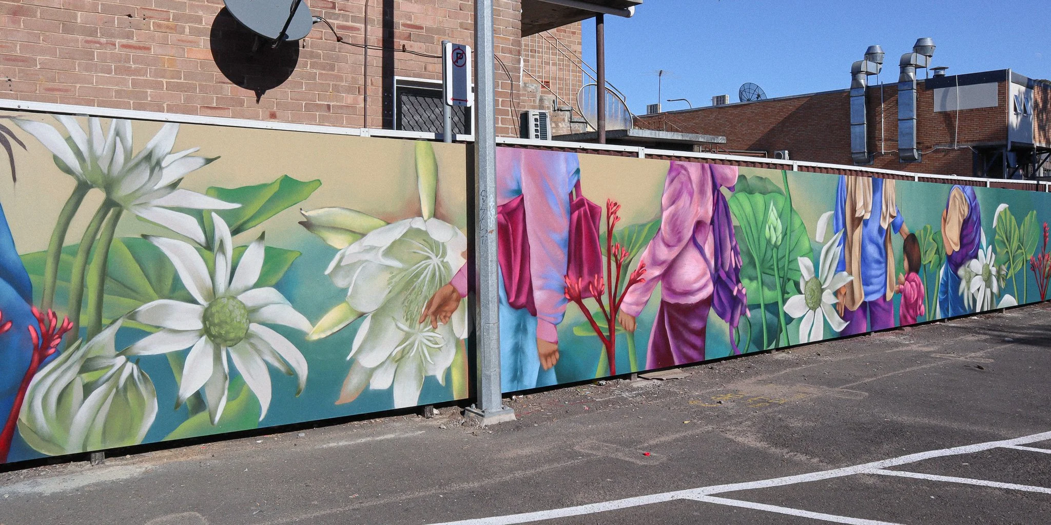 mural with people and flowers along fence