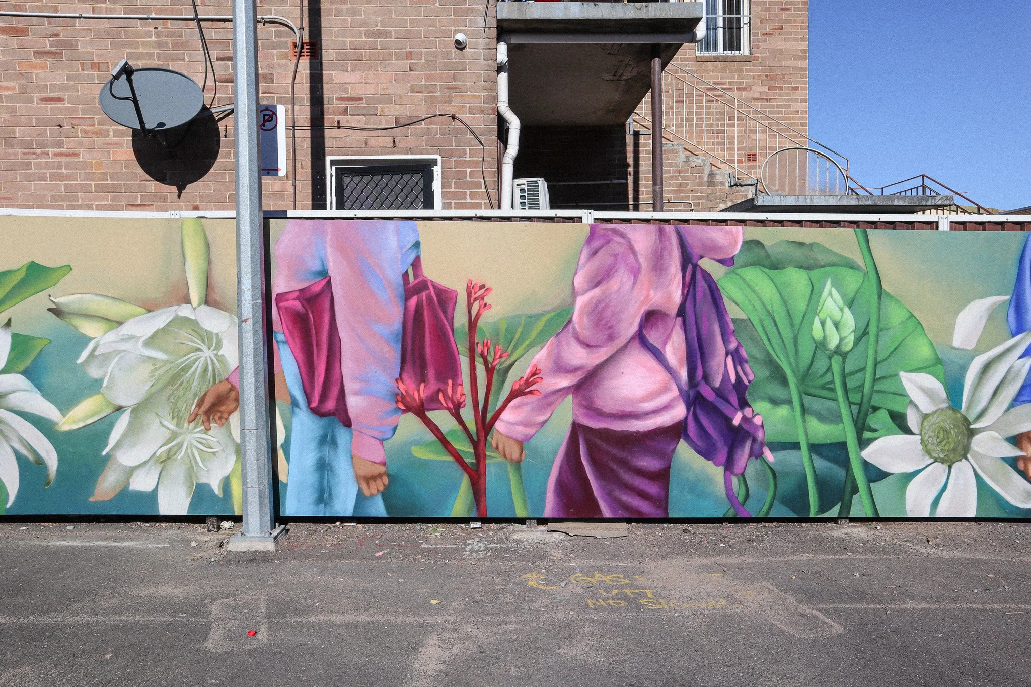 mural with people and flowers along fence