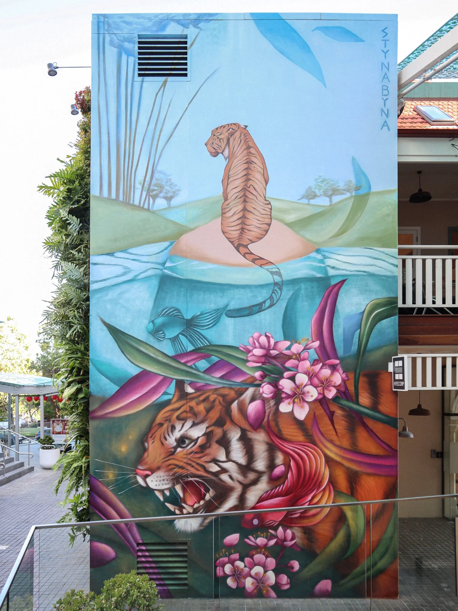 mural of tiger peering through flowers