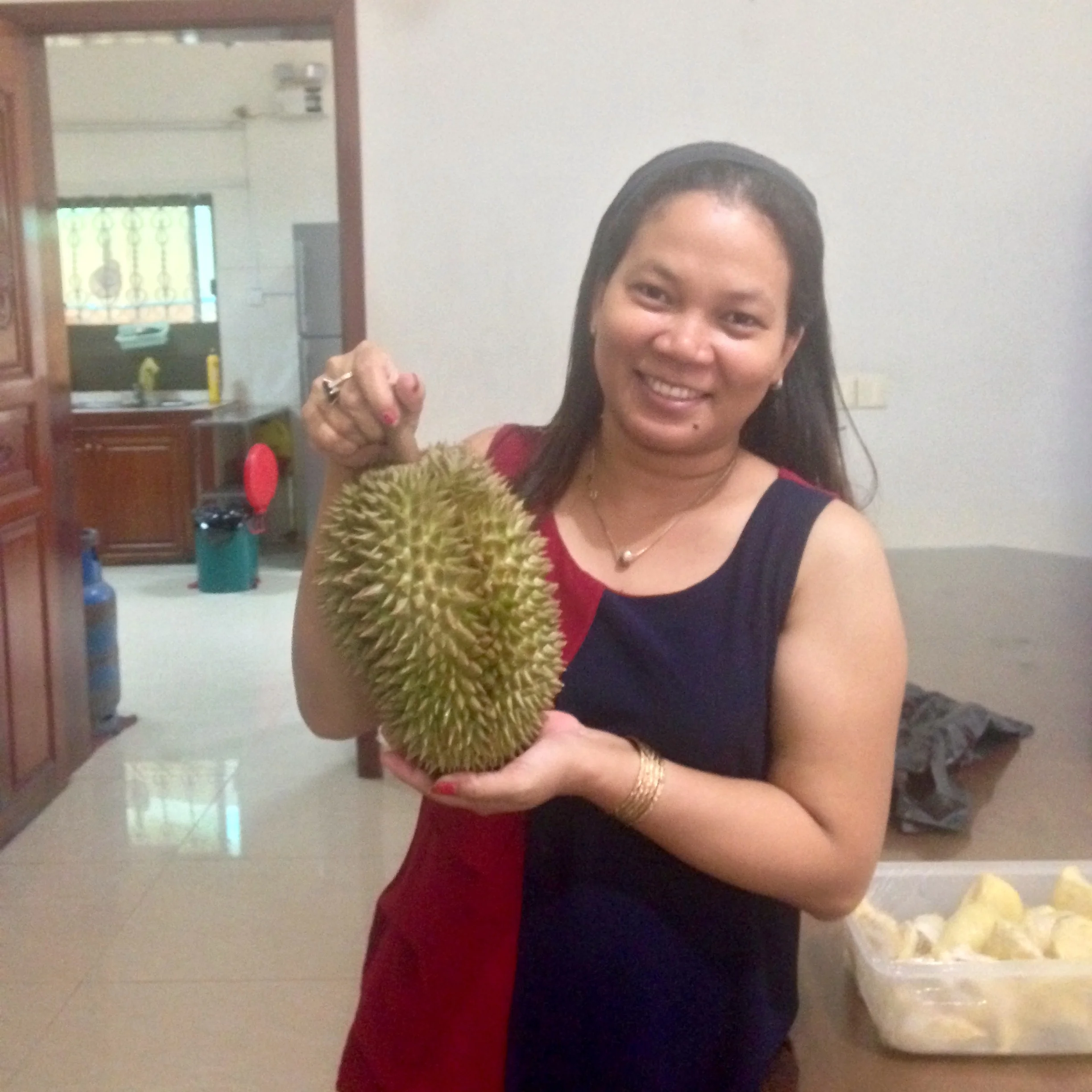 Avy holding a durian, a popular fruit in Southeast Asia with a rather pungent scent