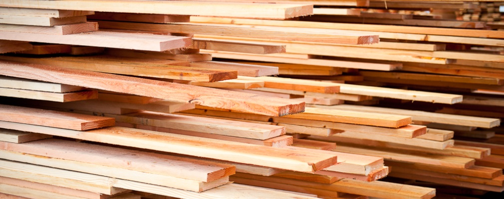 dimensional lumber pile with some planks pulled out at different places
