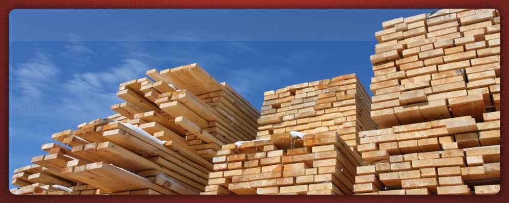 dimensional cut lumber stacked up in winter high into the blue sky