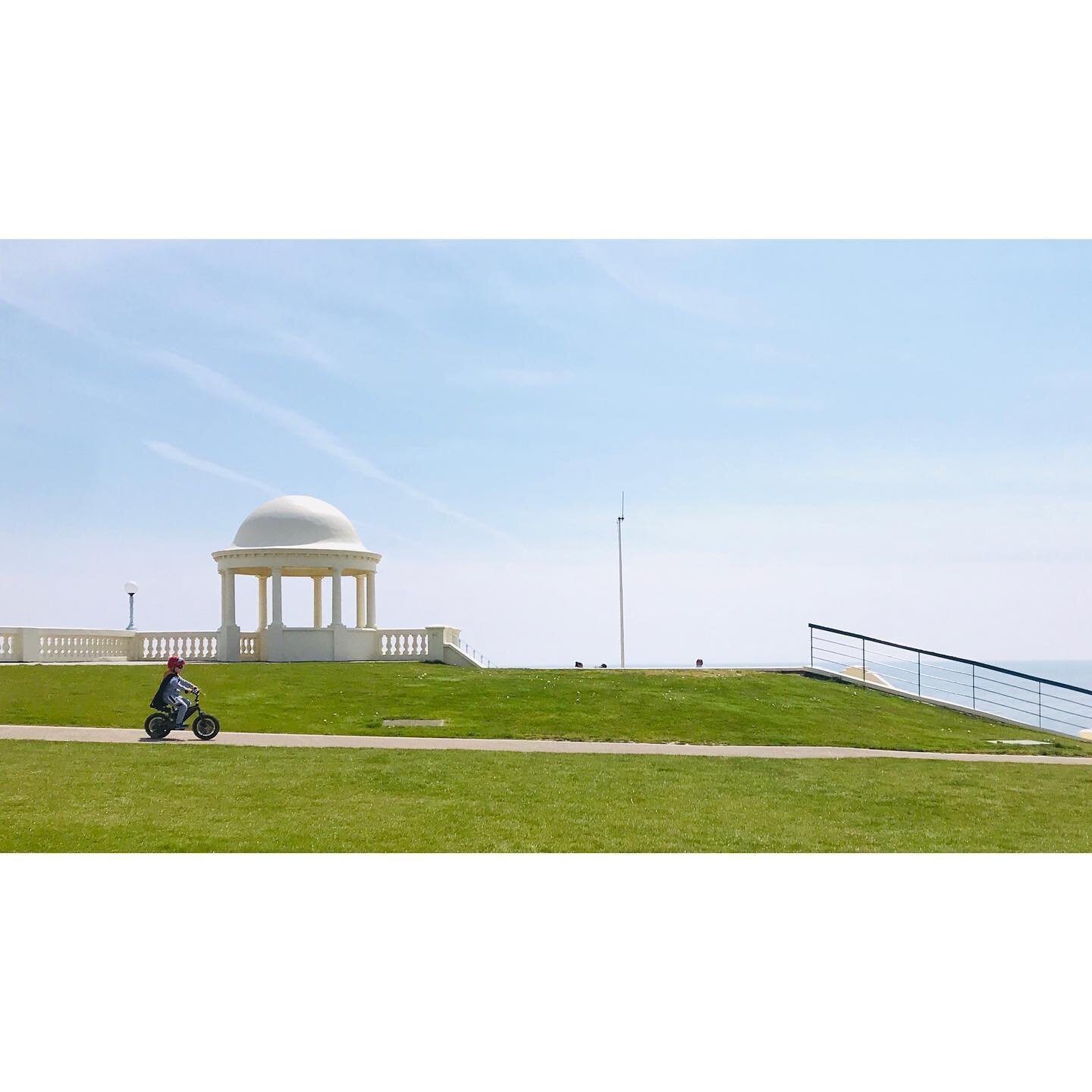 This little boy on his bike, dressed as a superhero (cape and batman visor just visible!) was enjoying the social distance.
.
.
.
.
.
.
#delawarpavillion #bexhill #socialdistancing #instadaily #superhero #youngboy #summer 
#composition