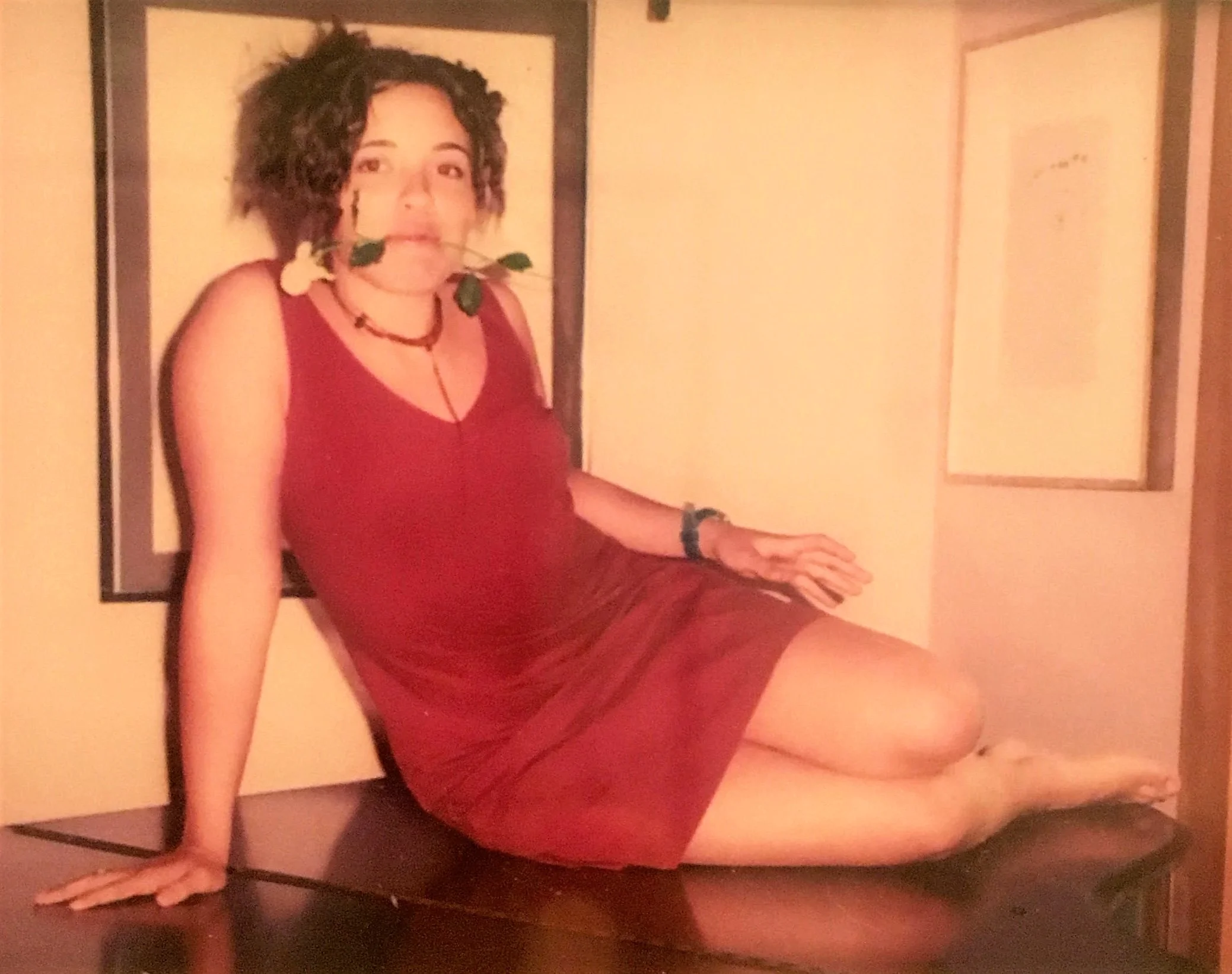 The author, age 13, at a music lesson, on top of the piano with a white rose.