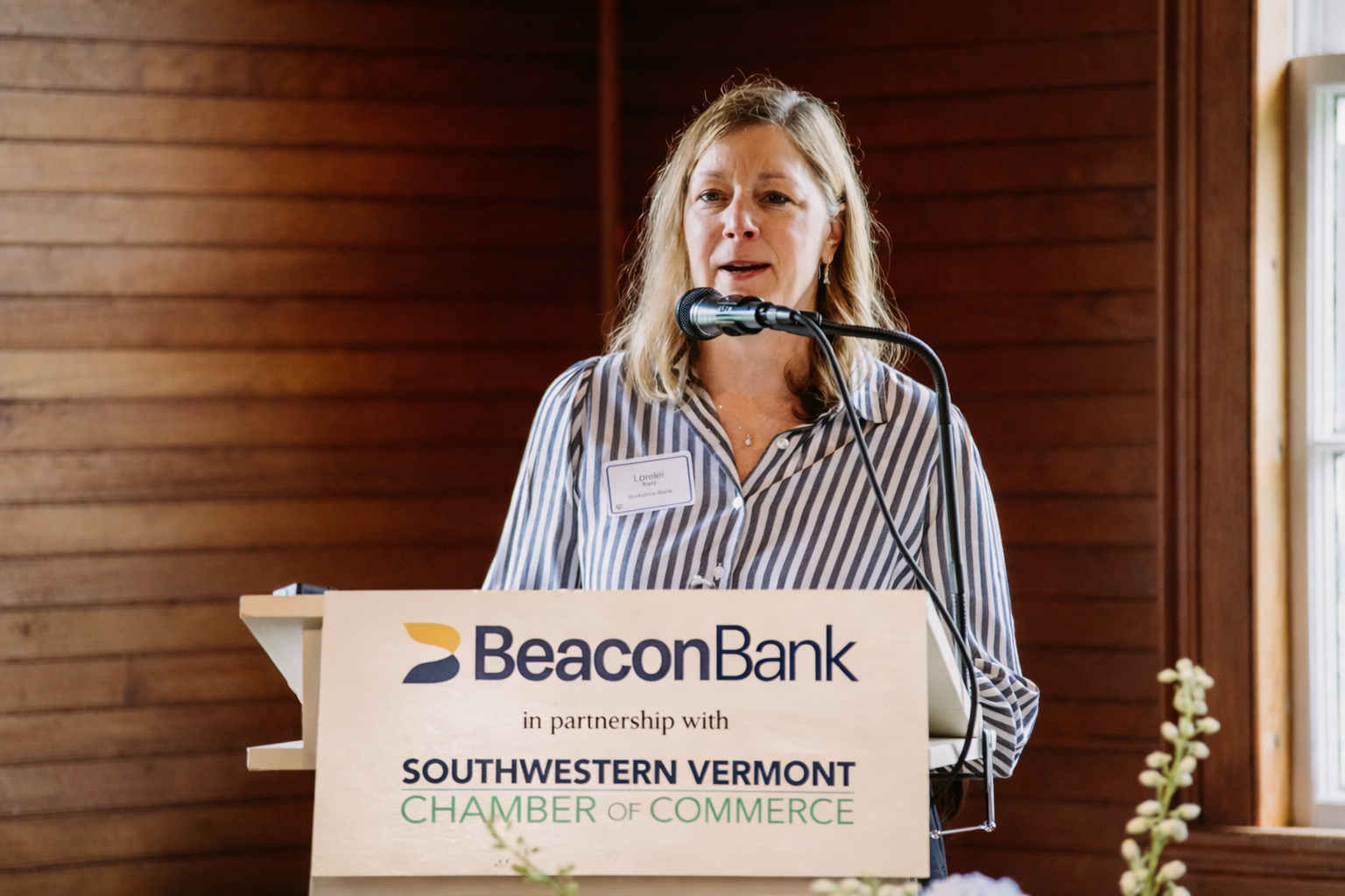 Lorelei Kiely speaking at event podium.png