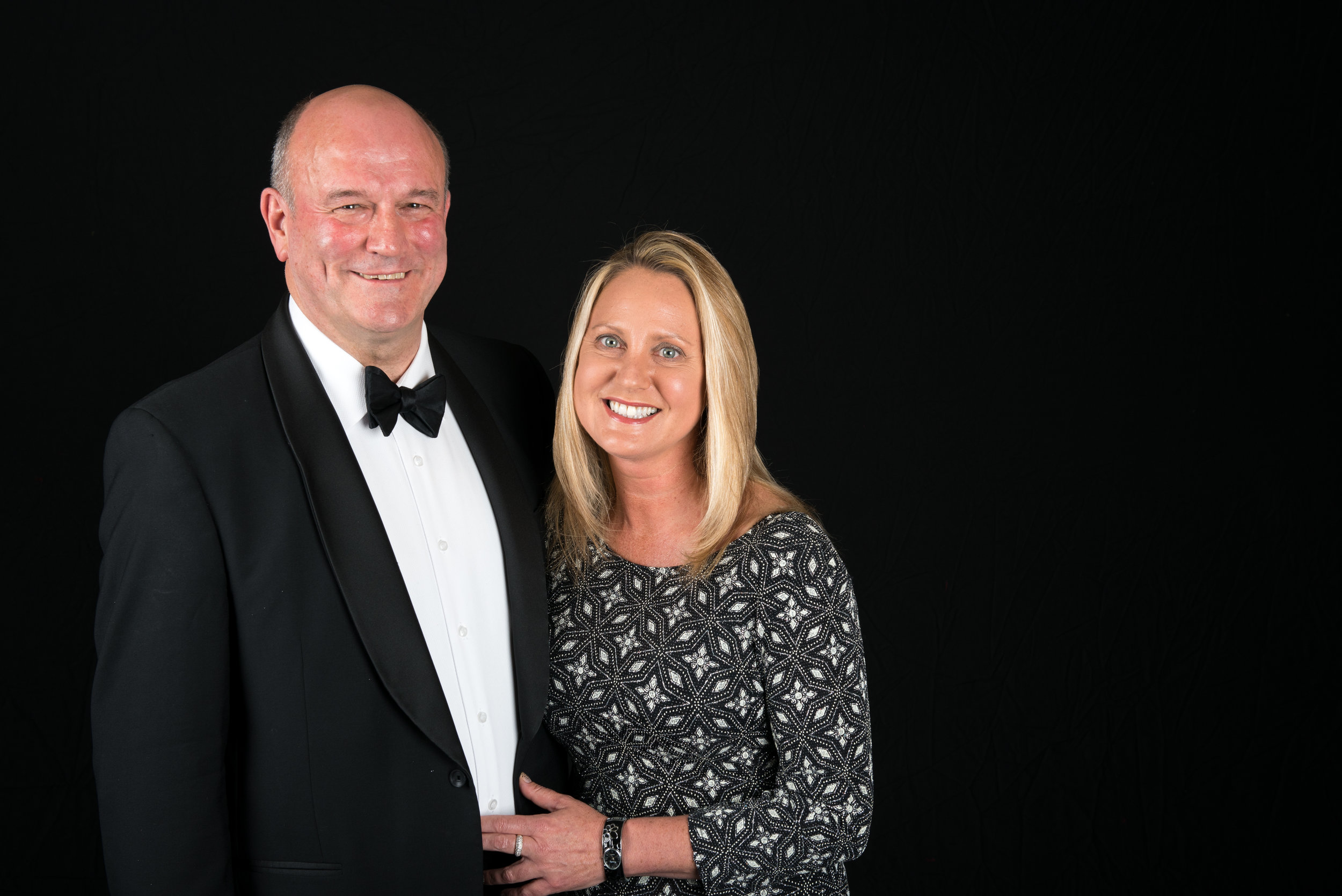 The Event A reunion of the crew and their partners of HMS Churchill. Featuring a full military brass band (amazing) What we offered We joined the event at the start, providing a separate studio area with our studio lighting and our massive 6m wide black backdrop. The client wanted the crew to be able to have their photos taken with their partner on arrival and to have one group photo of 50 or so crew members. Each 6x9" photo printed we charged £8 and we included a digital version that they could download at their lesiure from our website. We also included the HMS Churchill logo in the photos at the client's request. As it was a relatively small group of people we took a deposit, but this was refunded on a sliding scale once we had sold 25 prints. This helps us provide the service without any additonal cost. More photos are available to view our client collections area from the HMS Churchill shoot. The brass band were amazing. 