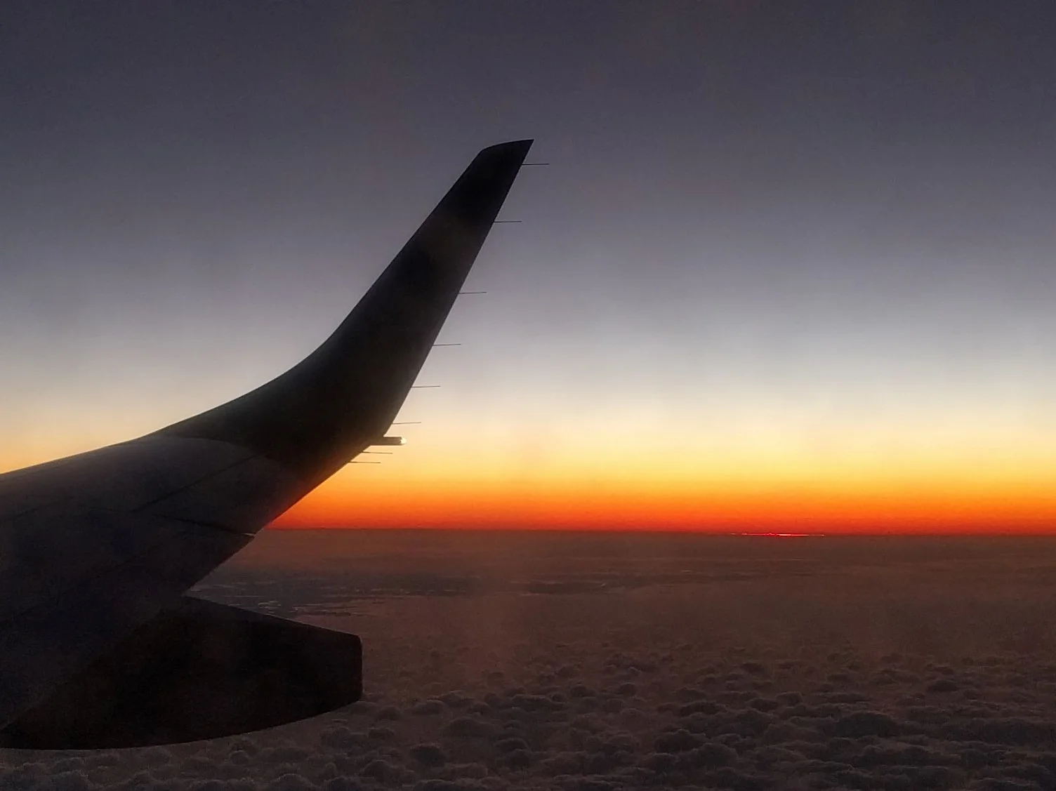 After zooming in, you can just barely make out the sliver of the sun over the horizon, struggling to keep up with the descending plane.