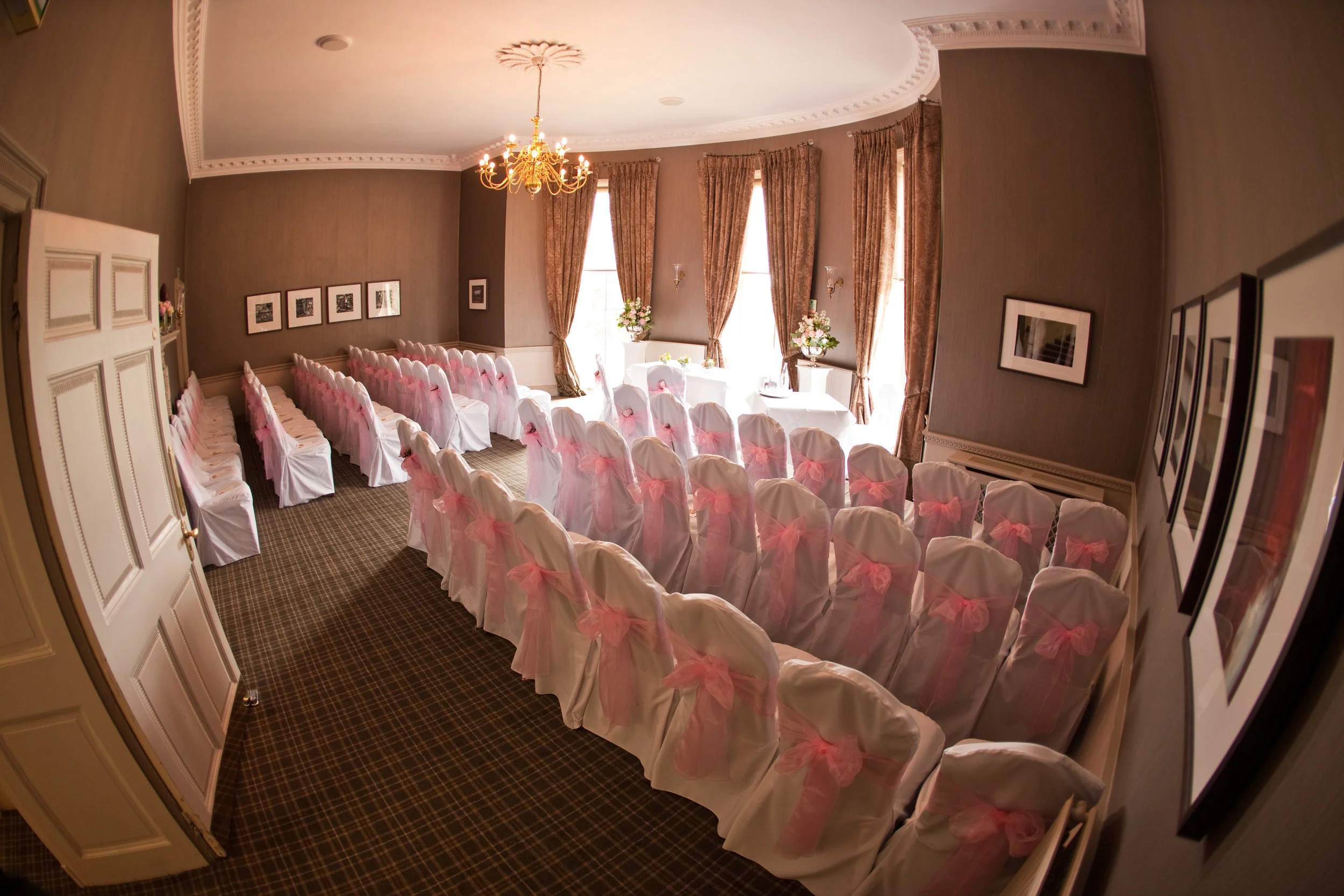 Width wise layout with short aisle with registrar's table in the window.