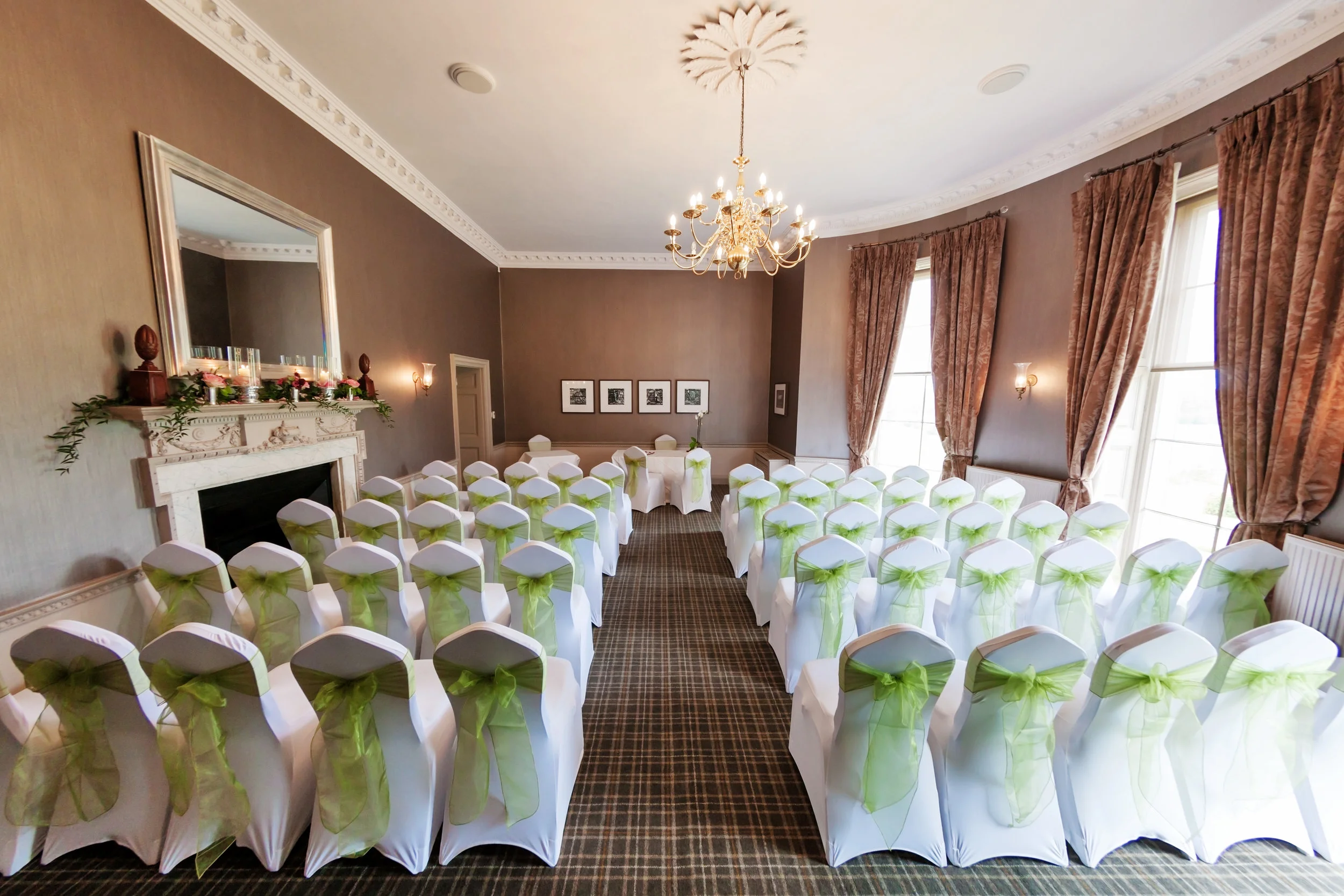 Length wise layout with long aisle and table at the far end of the room.