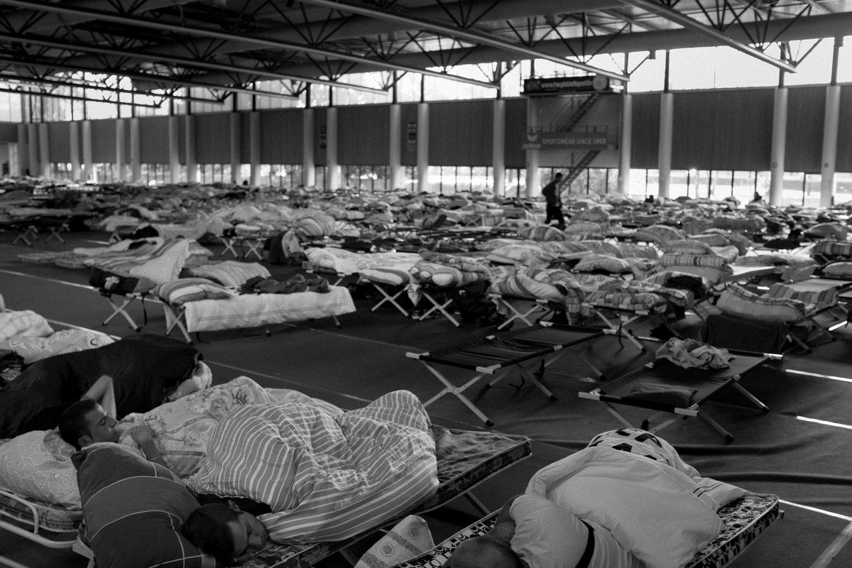  One thousand migrants and refugees from countries including Iraq, Syria, Pakistan, and Afghanistan, as well as regions of the Balkans and Africa at an emergency shelter at Olympia Stadiom in Berlin, Germany on September 24, 2015. 