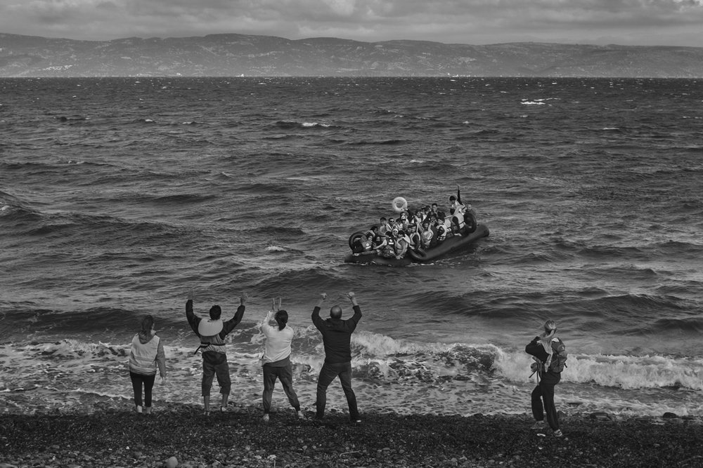  Refugees primarily from Syria, Iraq and Afghanistan are called to by volunteers as they land near Scala, on the island of Lesvos, Greece on September 30, 2015. 