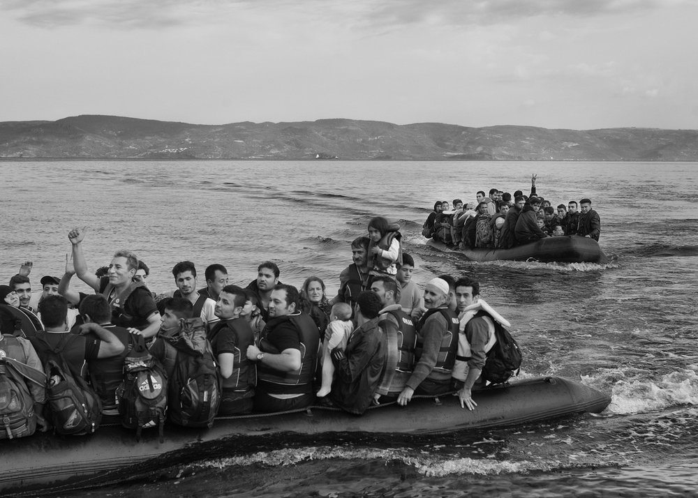  Refugees reach the Greek island of Lesbos after crossing through Aegean Sea from Turkey in dinghies on September 24, 2015. 