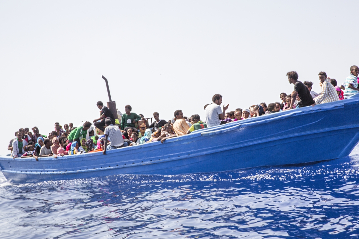 Strait of Sicily, September 2, 2015. Eritrean migrants are seen in their boat as they are about to be rescued 40 miles from the Libyan coasts by a ship hired by MOAS and MSF (Medecines sans Frontieres).