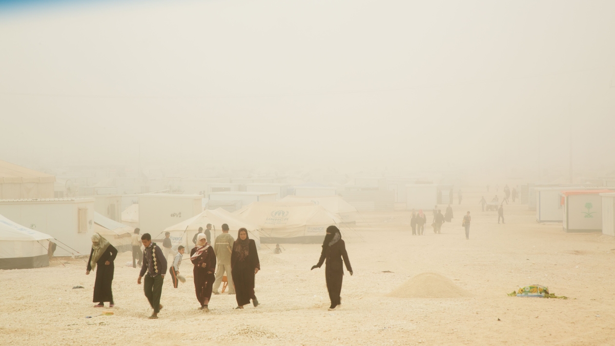  Refugees walk through the overcrowded Al Za'atri refugee camp for Syrians, near Mafraq, Jordan on Nov. 17, 2013. There, International Medical Corps, IMC, is pushing to increase awareness and improve not only the physical, but also the mental health 