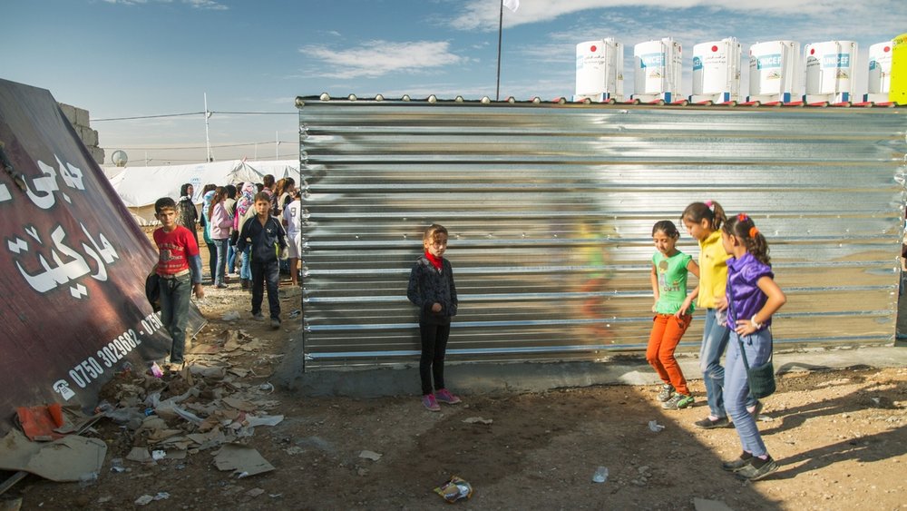  Young girls practice a dance together at the Domiz Refugee camp for Syrians, located just outside of Dohuk, Iraq, on Nov. 21, 2013. 