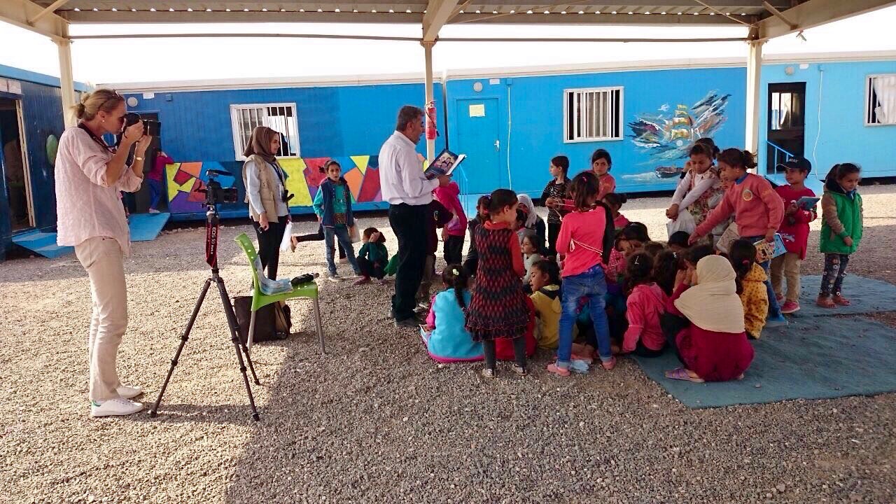 Photographing a reading session in Azraq Camp - Village 2