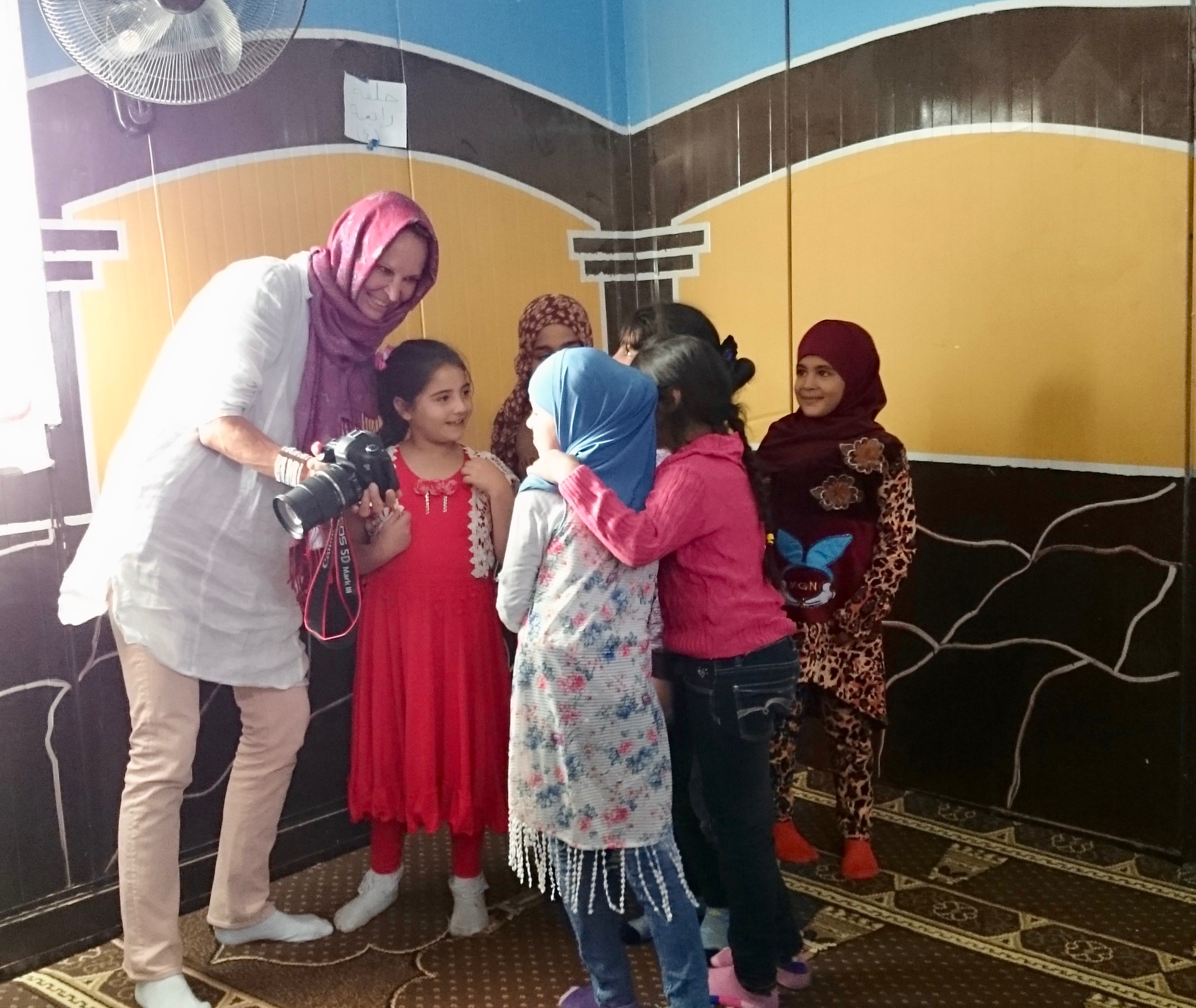 Sharing photos with young girls in the mosque in Village 6