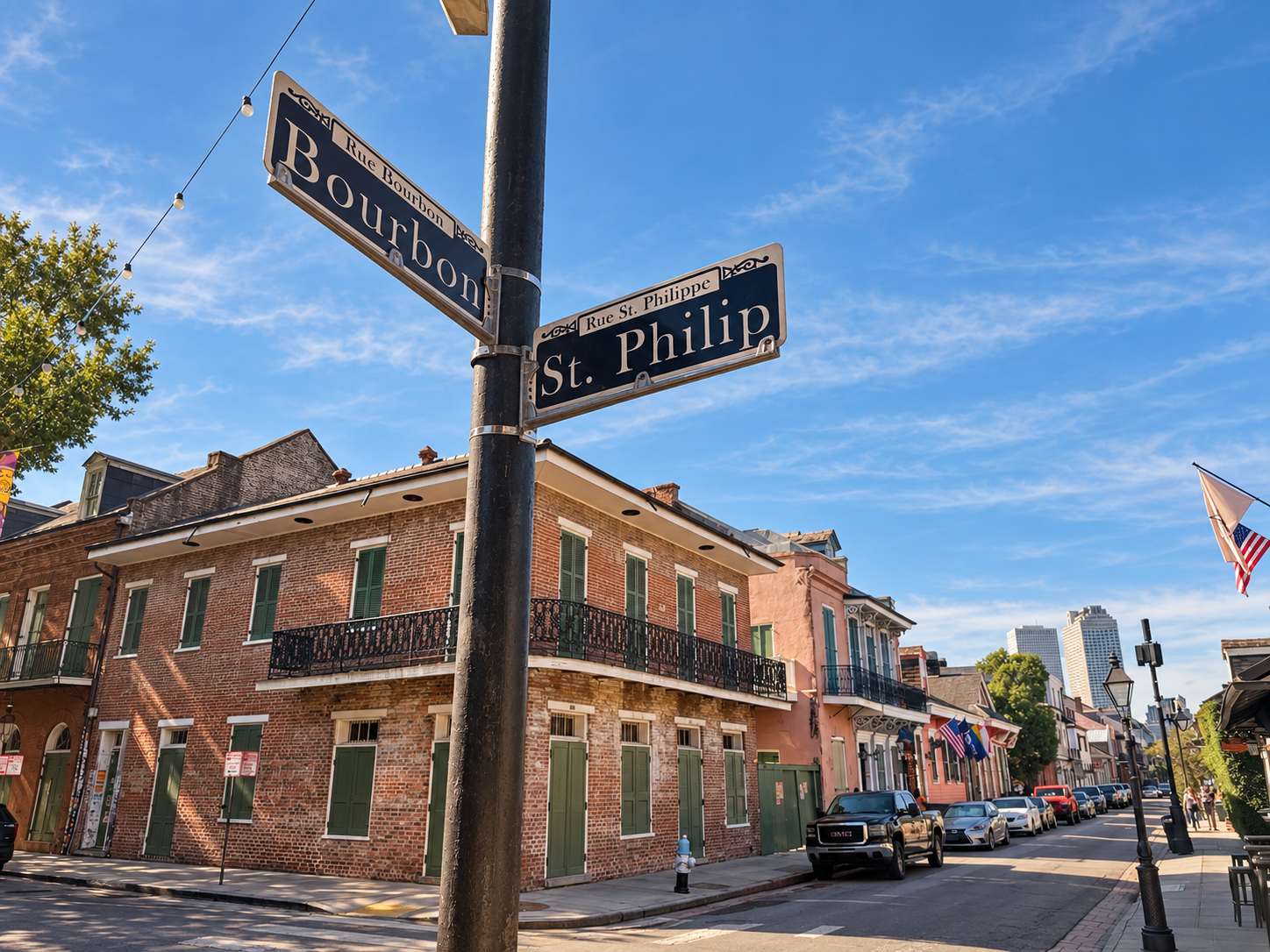 Saint Philip and Bourbon street signs above historic French Quarter buildings in New Orleans.